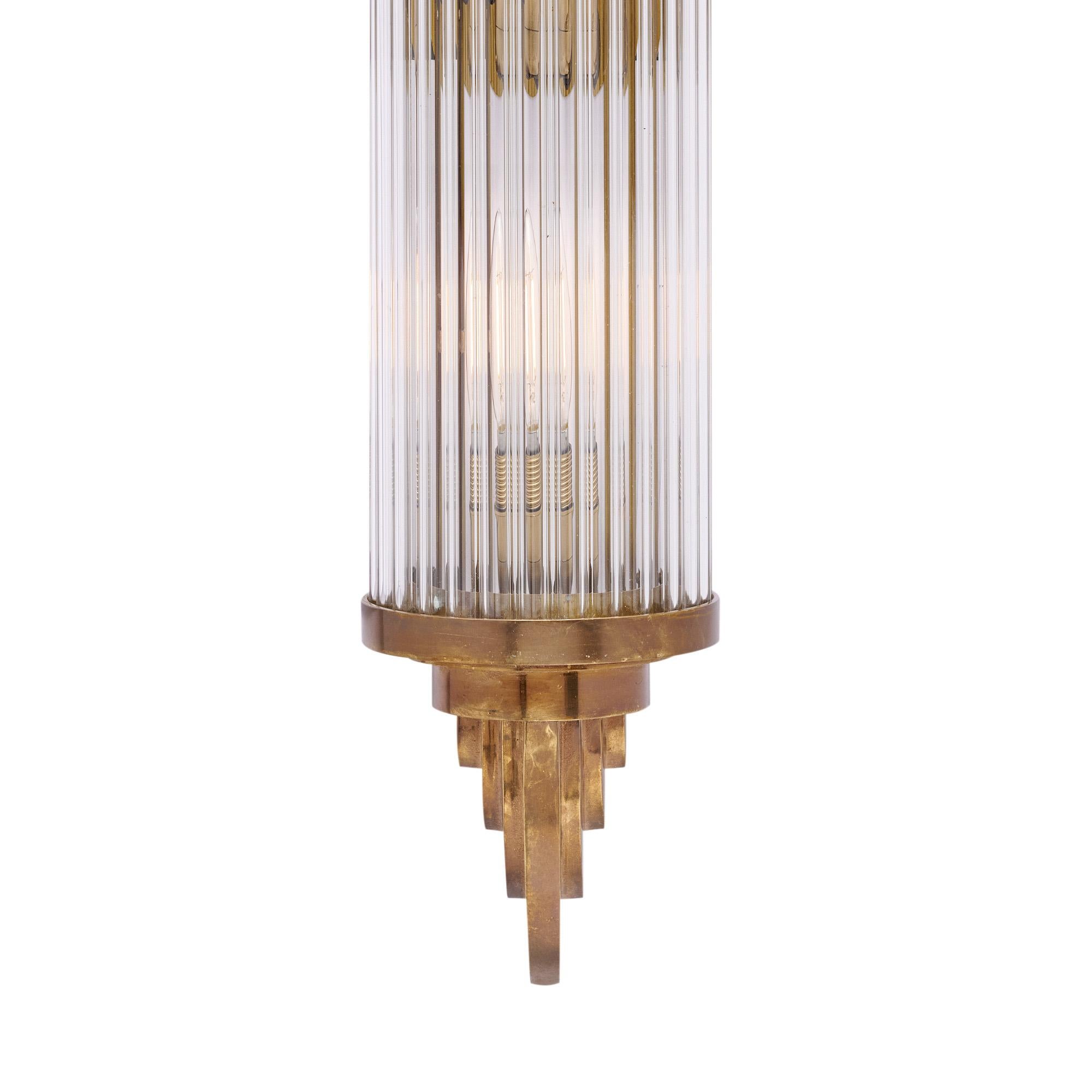 Set of sconces available from the Art Deco period made in France. Each sconce has a bronze structure in the Art Deco style. Hand-blown glass rods are held in place around the light source. These sconces have been newly wired to fit US standards and