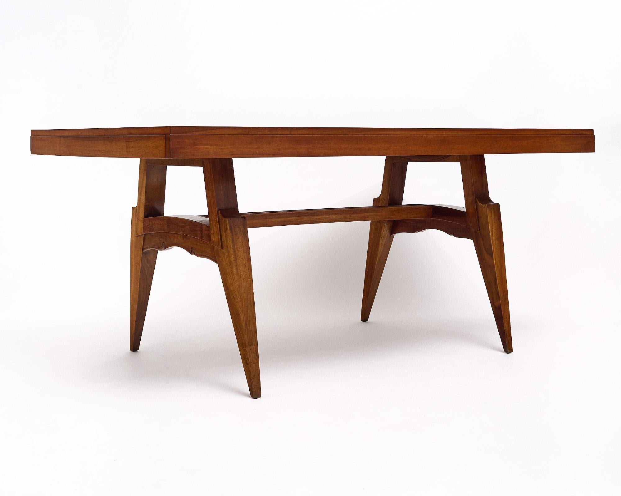 Dining table from the Art Deco period in France made with a beautiful rosewood parquetry top. The curved legs and detail to the stretchers give this table significance. It has been finished in a lustrous museum-quality French polish.