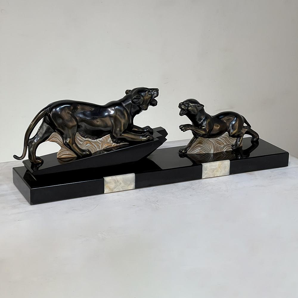 Art Deco Period French sculpture of tigers on polished slate base depicts the ageless concept of the survival of the fittest. One cannot be entirely sure if it is part of the courting ritual, or a juvenile challenging the patriarch of the pride, but