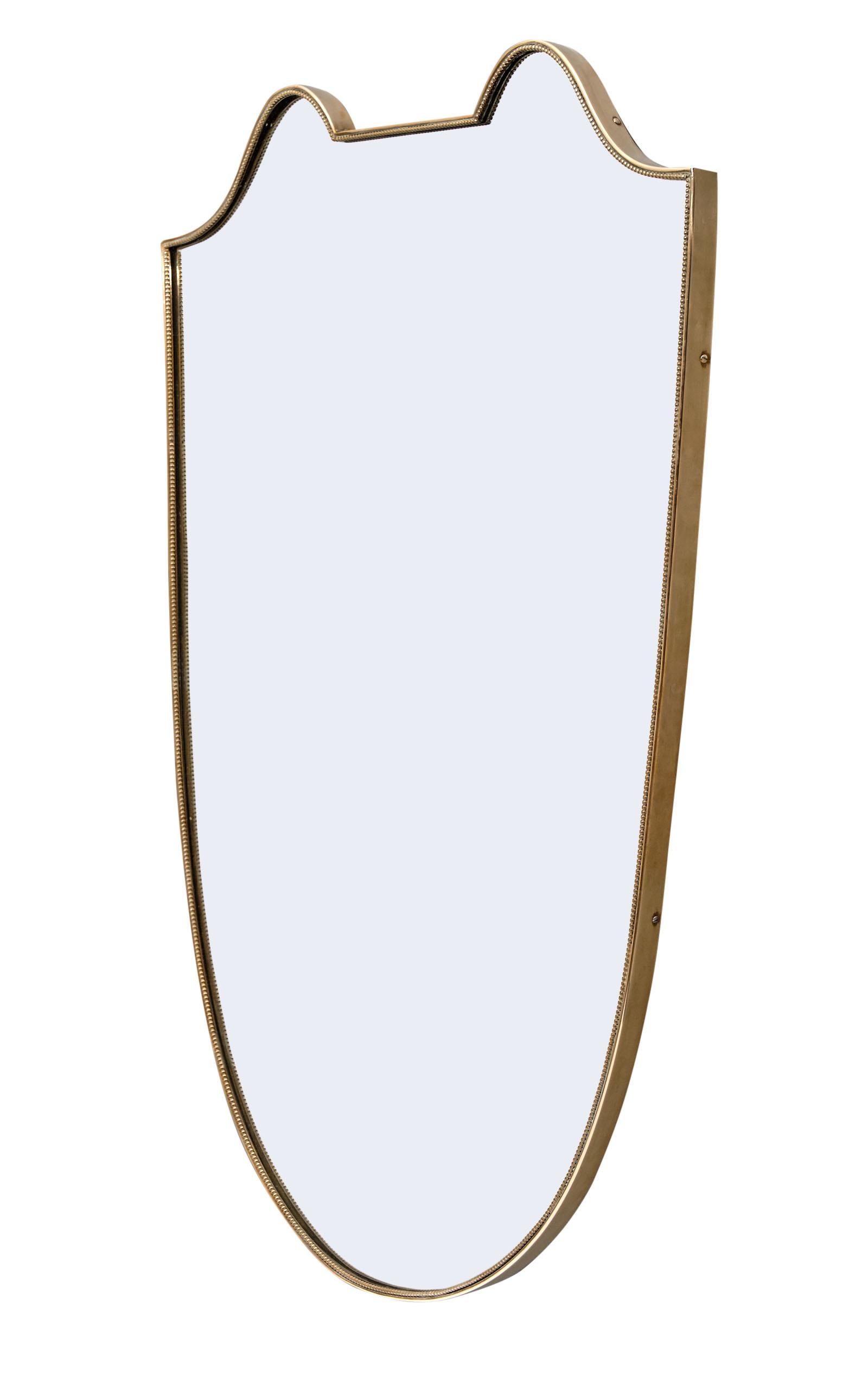 Italian Art Deco period mirror with a brass frame highlighting beautiful curved lines. We love this unique and authentic piece!