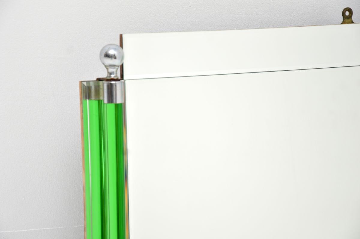 A stunning Art Deco period mirror, made in England and dating from the 1930’s.

This is beautifully made and has a gorgeous design, with two clear green tubular columns on the sides which have chrome spherical fixtures at the top and bottom.

The