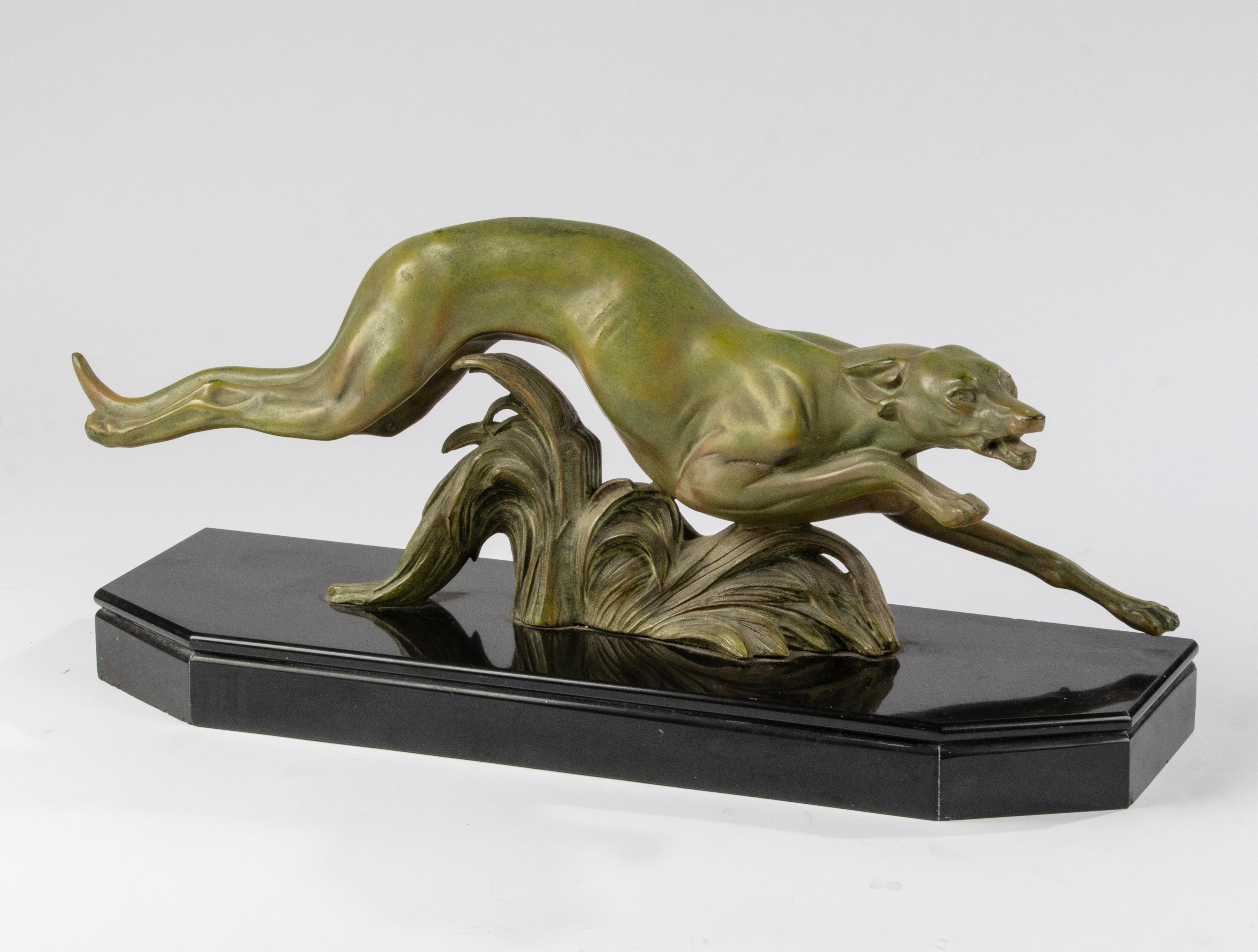 A graceful sculpture of a Greyhound / Whippet dog. The dog figurine is made of green patinated spelter (zinc alloy). On a black Belgian marble hexagonal plint. Signed on the back: France. Artist unknown.
Dimensions: 23 (h) x 58 x 17 cm
Free shipping