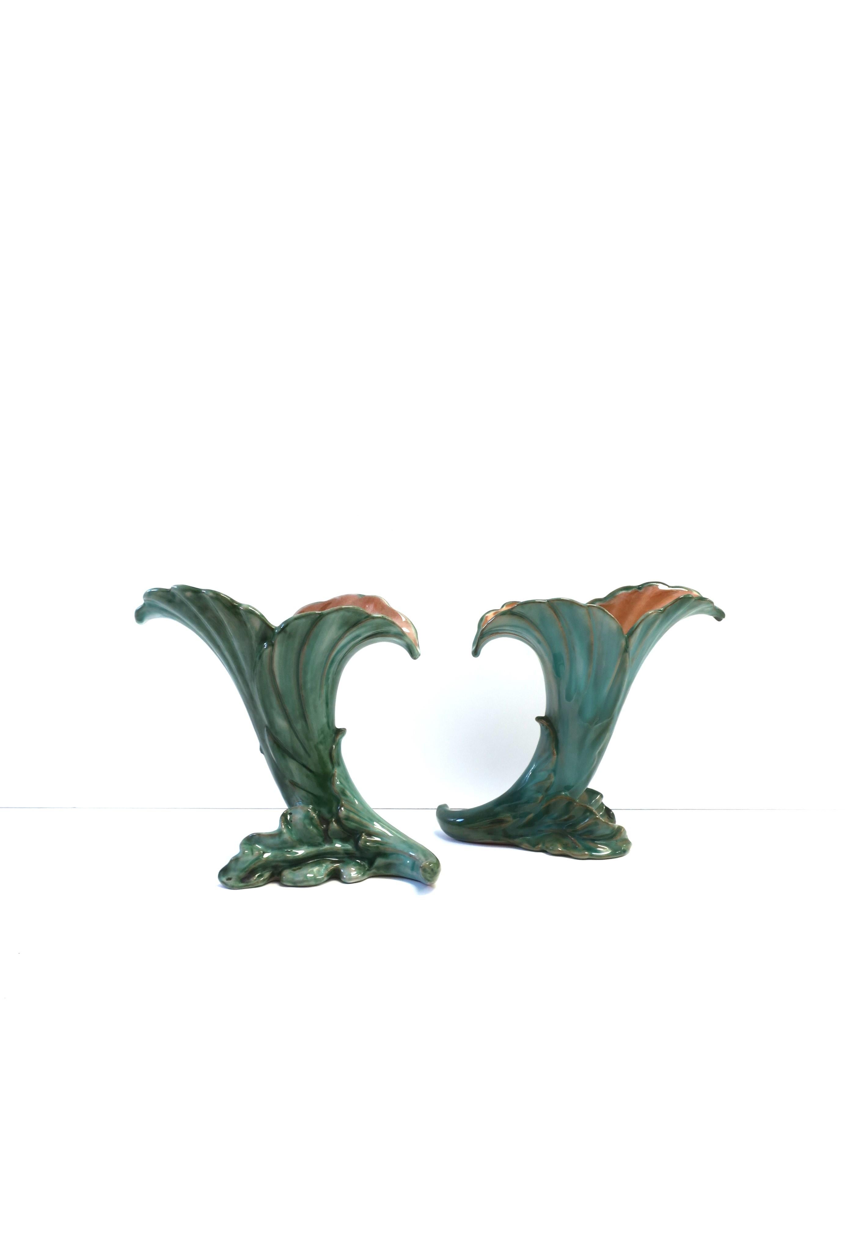 A beautiful and rare pair of hand-painted terracotta pottery vases with green leaf design, Art Deco period, by Stangl, circa early-20th century, USA. Pair are hand-painted in light, medium, and dark green hues and a hit of dark brown, beautifully
