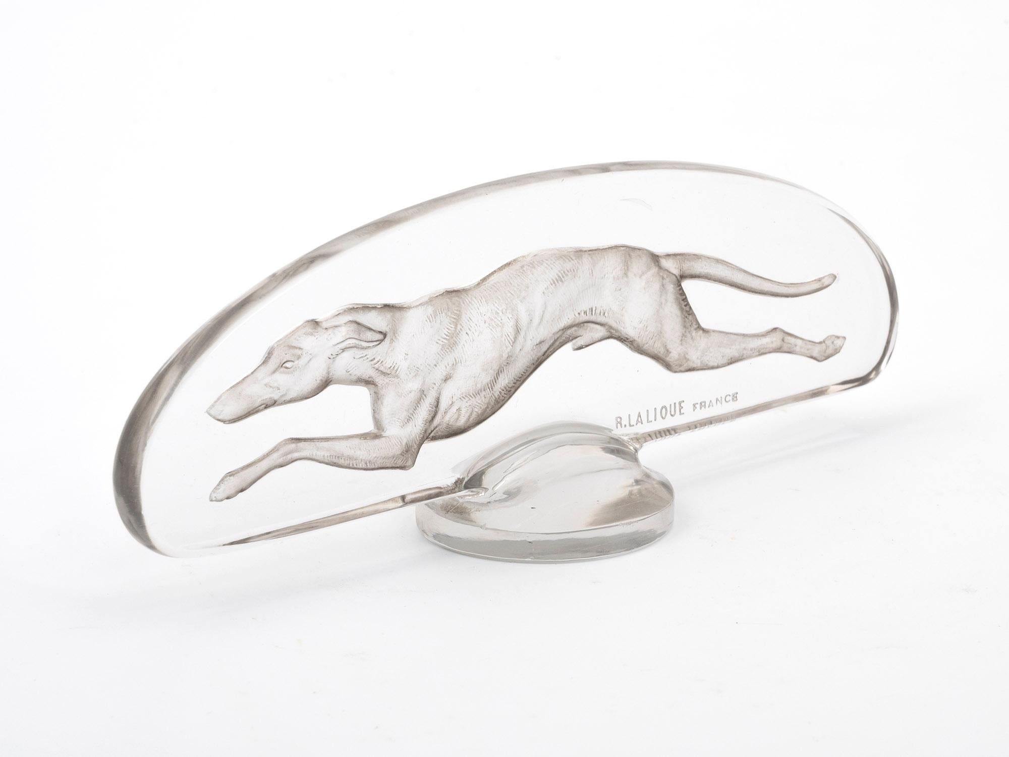 This Levrier (Greyhound) Car Mascot was designed and produced by renowned glassmaker René Lalique. Mesmerizing, this piece is clear in colour, with a lovely bright reflection and patination.

This René Lalique Greyhound Car Mascot bears a finely