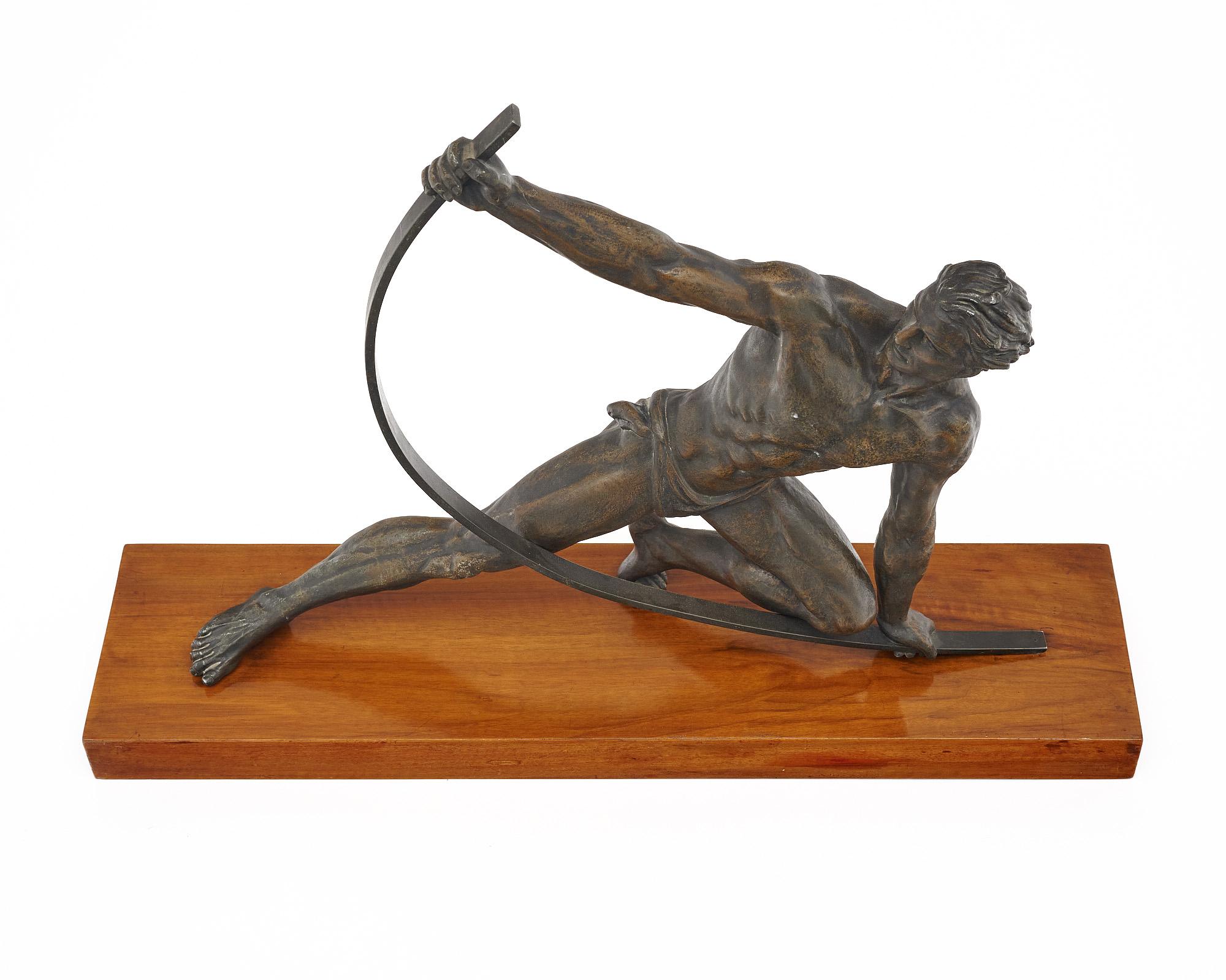 Art deco statue of an archer with drawn bow made of patinated spelter. The sculpture sits on a wooden base. The figure is in very good vintage condition and is unsigned.

Attributed to the “Spartiate” or Archer sculpture originally cast in the