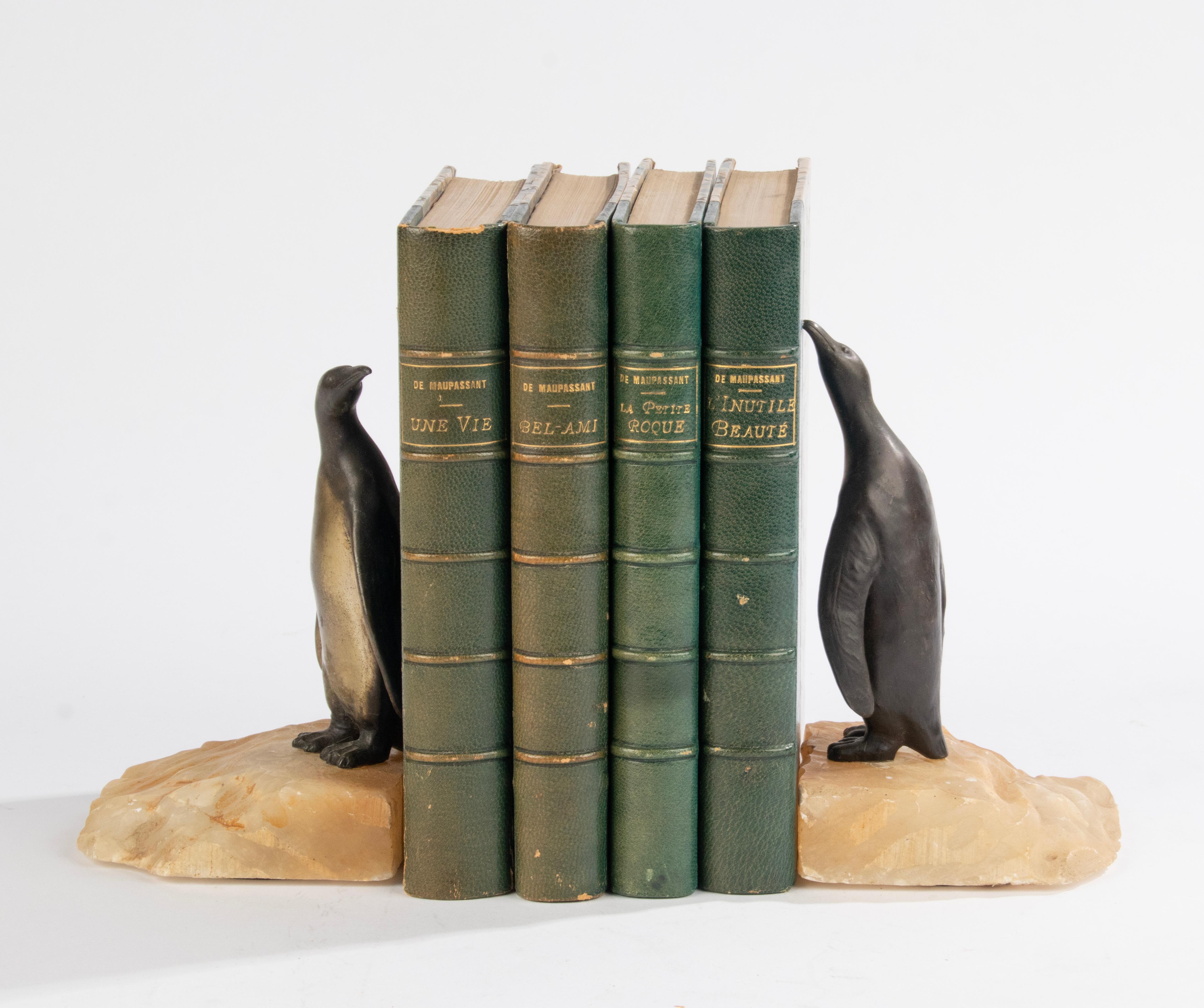 An adorable pair of Art Deco bookends with penguins. The penguins are made of dark gray with gold patinated spelter. Standing on an alabaster base. The sculptures are not signed. Made in the Art Deco period of France, 1920-1930.

Dimensions: 14 (h)