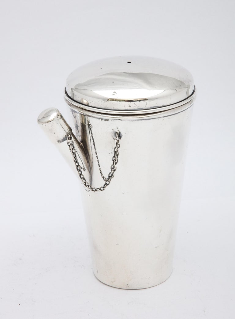 Art Deco Period, sterling silver cocktail shaker, Marcus and Company, New York - makers, Ca. 1935. Measures 5 1/4 inches high x 3 1/4 inches diameter at widest point x 4 inches wide from outer edge of spout to outer edge of handle. Weighs 6.780 Troy