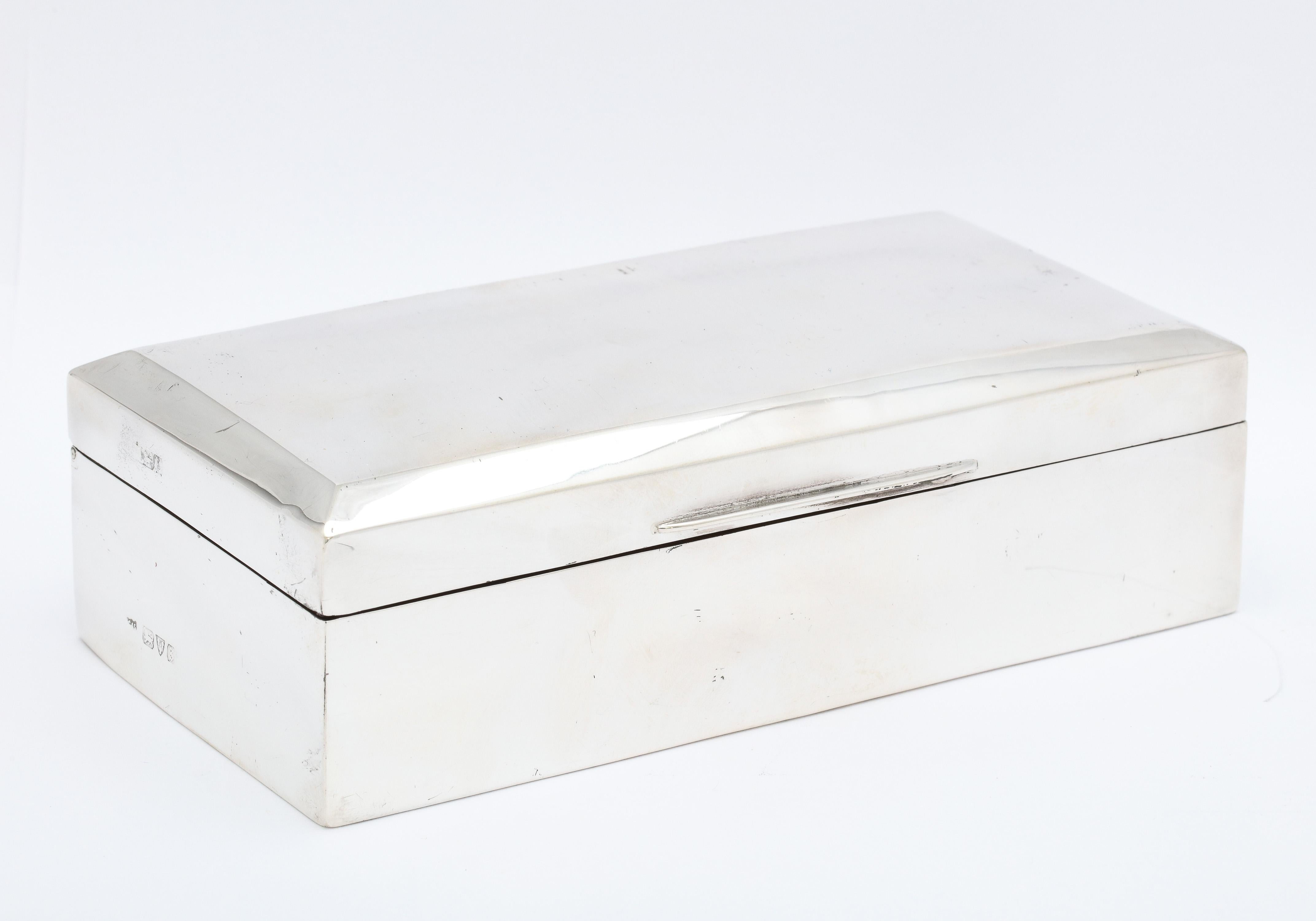 Art Deco Period, sterling silver jewelry box with hinged lid, Chester, England, year-hallmarked for 1927. The jewelry has a wooden interior that has dark blue velvet separators for rings, earrings, brooches, etc. The underside of the lid is also
