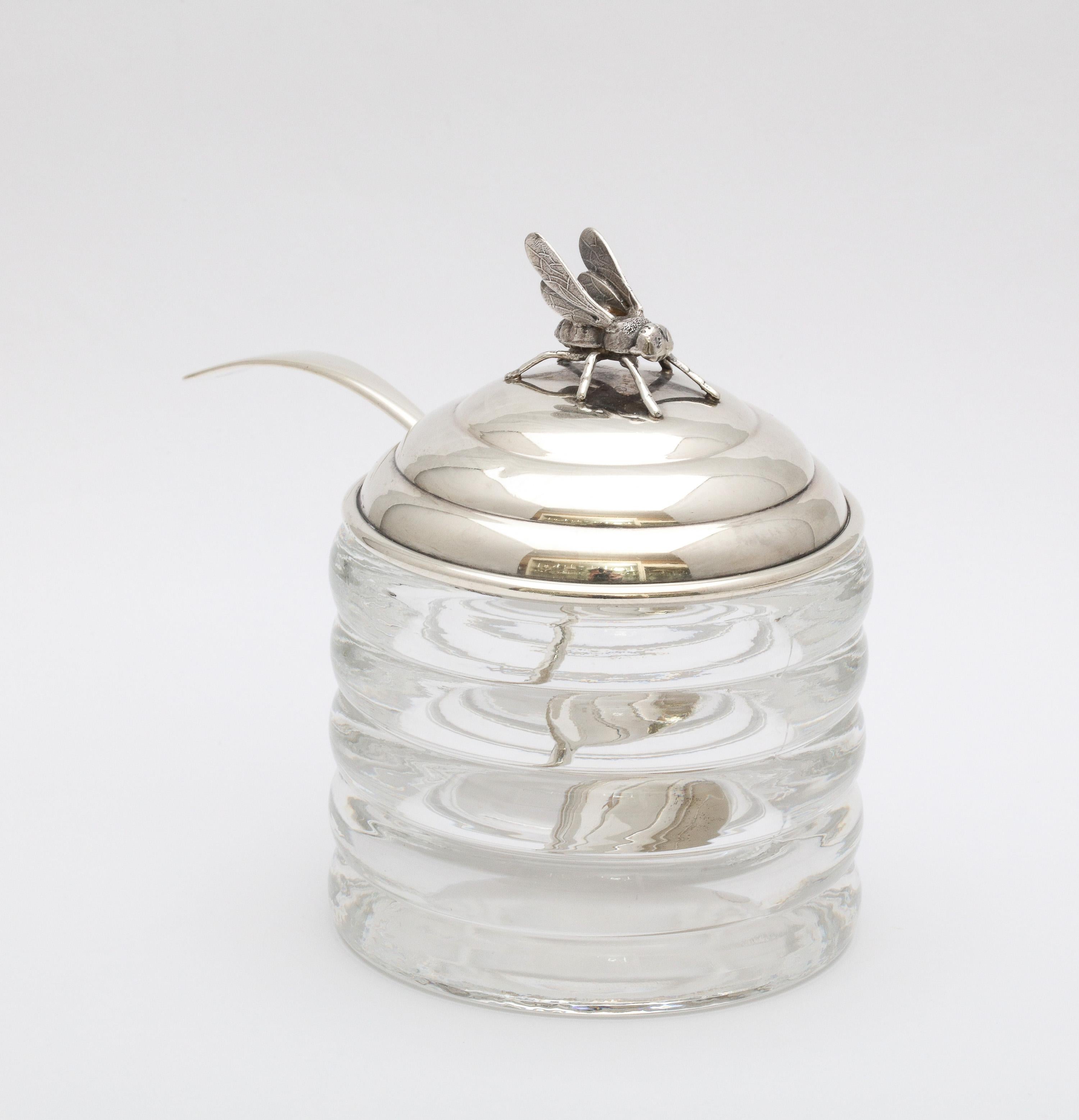 Art Deco Period, sterling silver-mounted honey jar with original honey spoon, R. Blackinton and Co., North Attleboro, Mass., Ca. 1930's. Glass is beehive-form; sterling silver lid is topped by a honey bee finial. Underside of sterling silver lid is