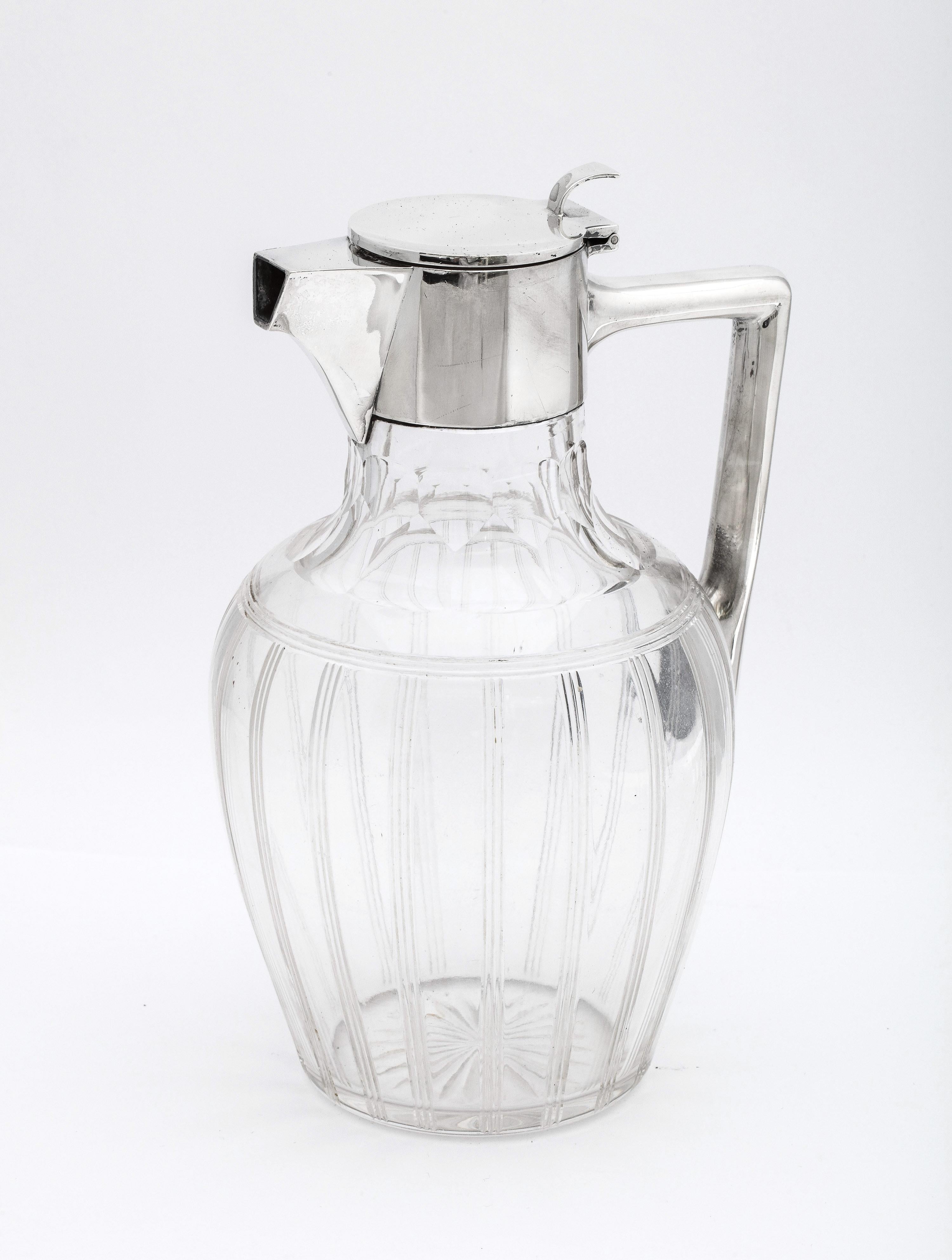 Art Deco period, sterling silver-mounted claret jug, Sheffield, England, year-hallmarked for 1926, Walker and Hall - makers. Lovely, tuxedo-striped glass. Measures 8 3/4 inches high (at highest point) x  5 1/2 inches wide (from outer edge of handle
