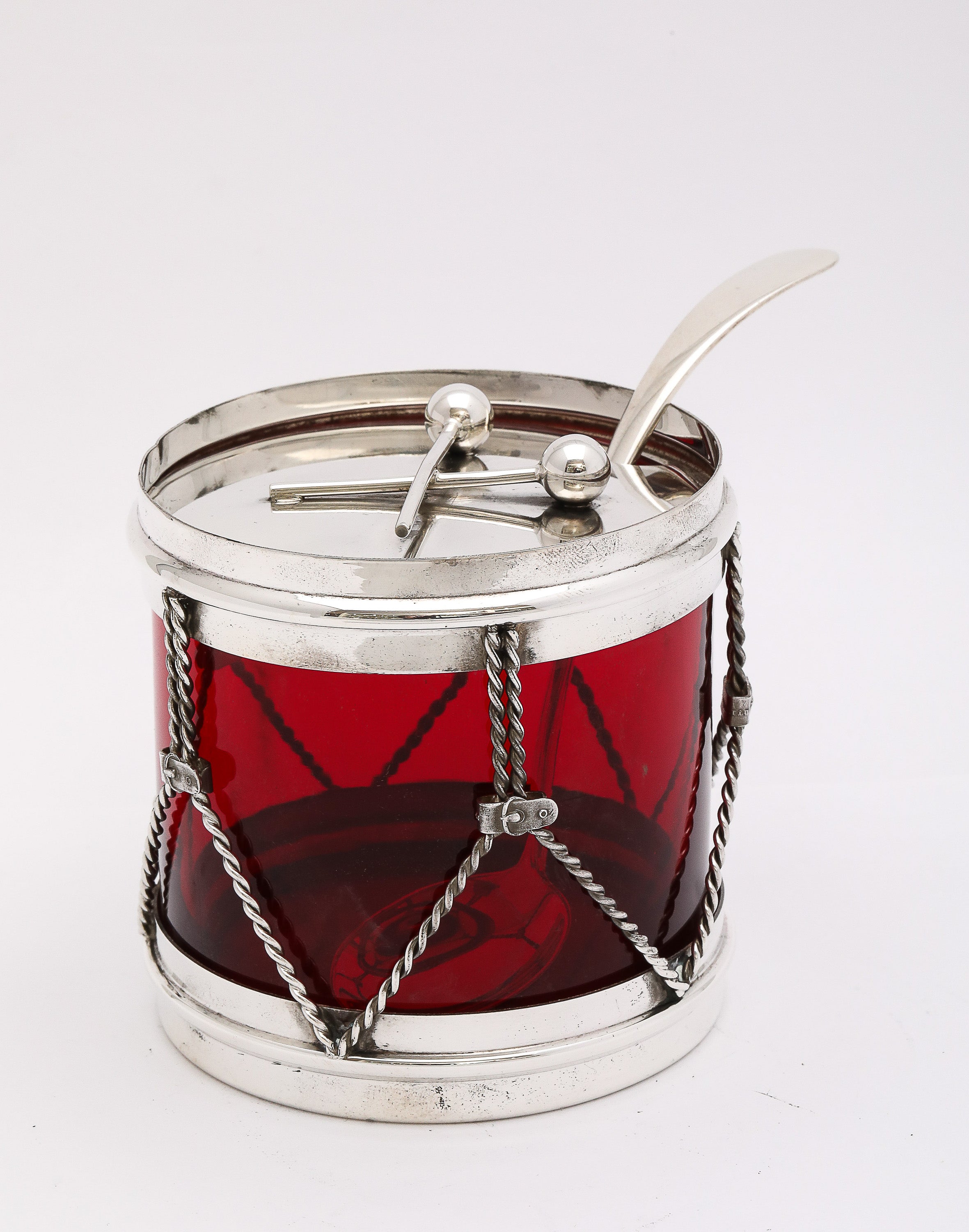 Art Deco Period, sterling silver-mounted red glass, drum-form jam/jelly/condiments jar with original sterling silver spoon, R. Blackinton and Co., North Attleboro, Mass., Ca. 1930's. Crossed drumsticks serve as the handle to lift the lid. Red glass