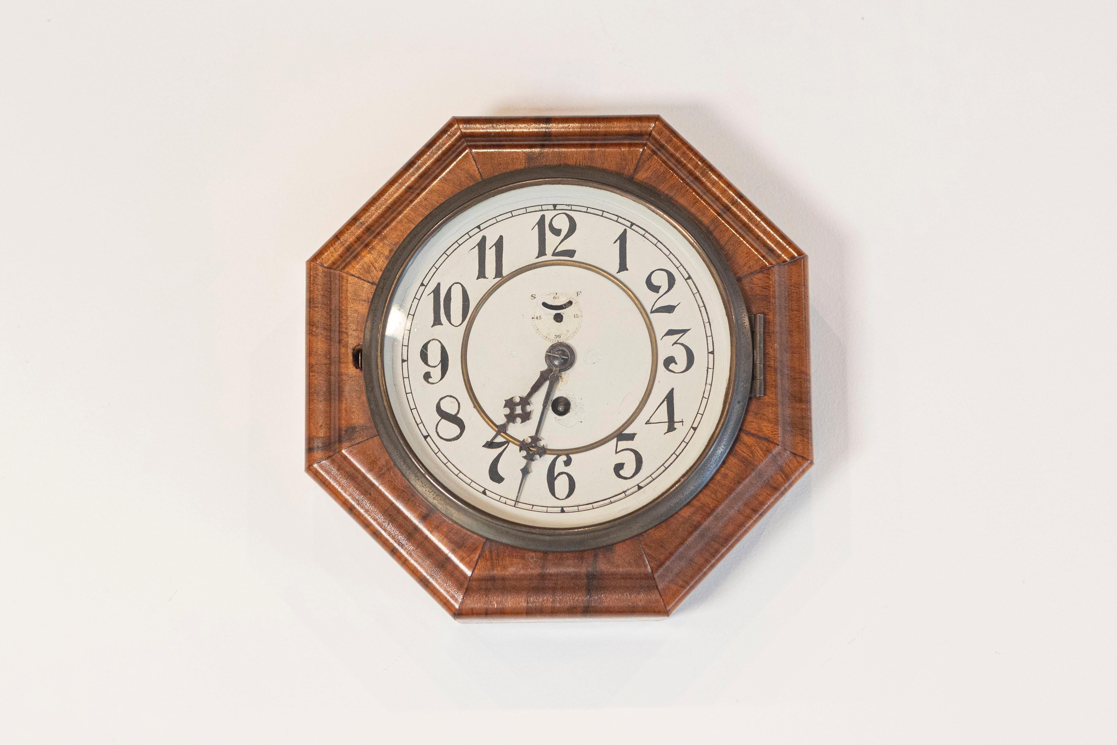 Art Deco period walnut octagonal wall clock by well known German clock maker Junghans, circa 1920. Celebrate the timeless elegance of the Art Deco era with this Walnut wall clock by Junghans, the renowned German clock maker. Crafted circa 1920, this