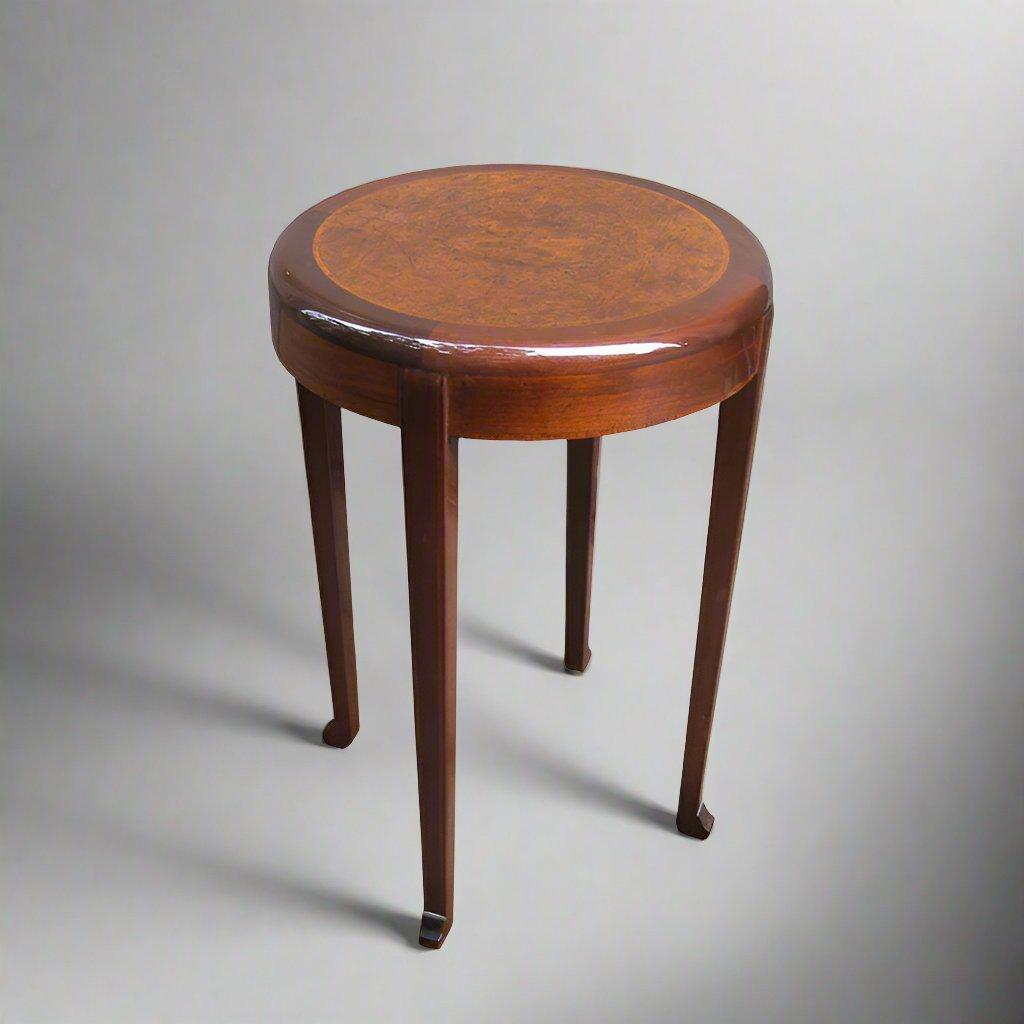 An Art Deco period table with a segmented burl and marquetry top. The four legs each ending in a Chinese style “Chou” foot imbue the table with an elegant air. Signed: R. Deralle
