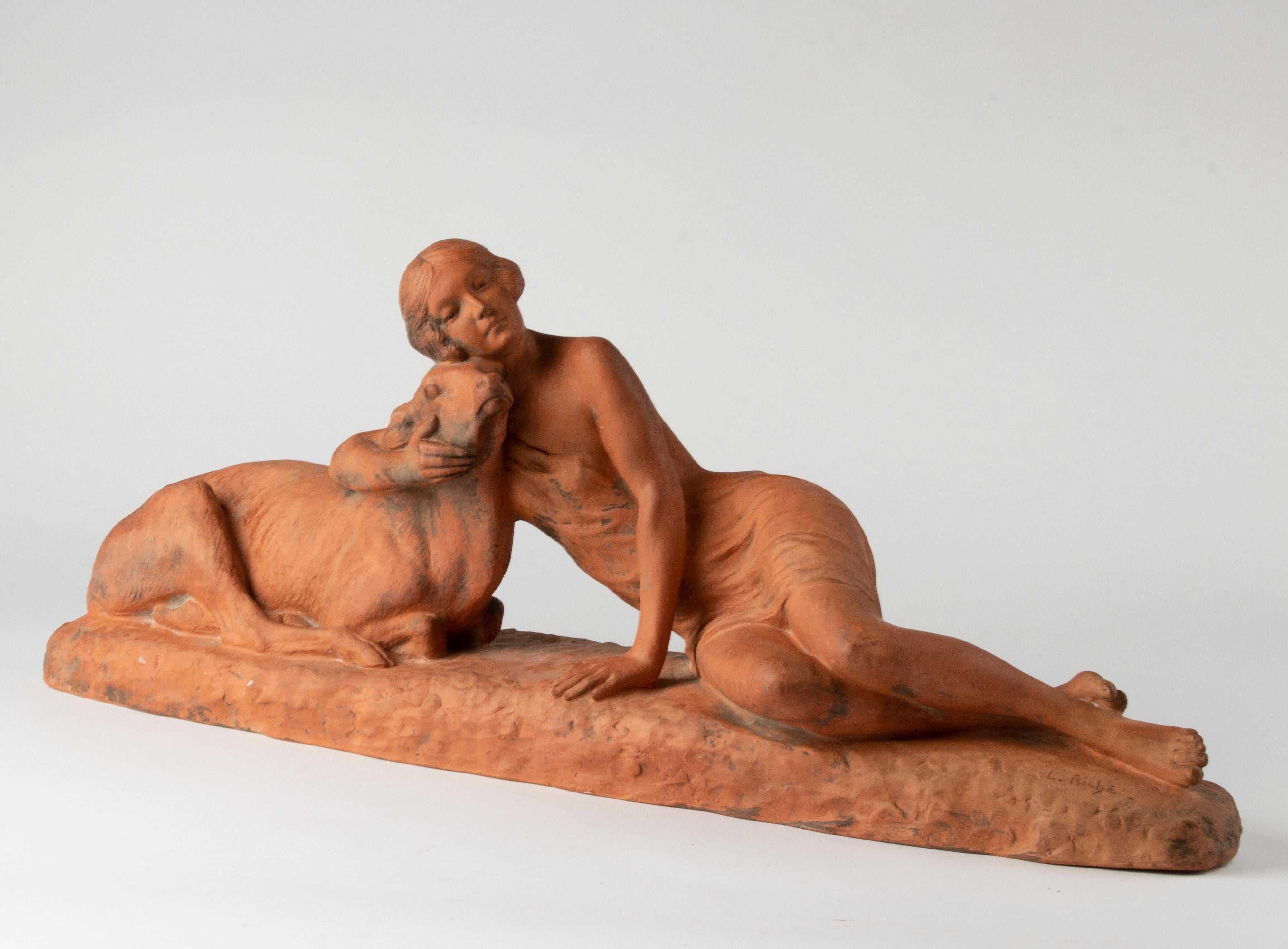 Large unglazed terracotta sculpture depicting a young woman with a sheep. Signed at the plinth. The sculpture is in good good condition and has a nice old, vivid patina. 

Louis RICHÉ, France, 1877-1949
His first exhibit at the Salon in Paris was