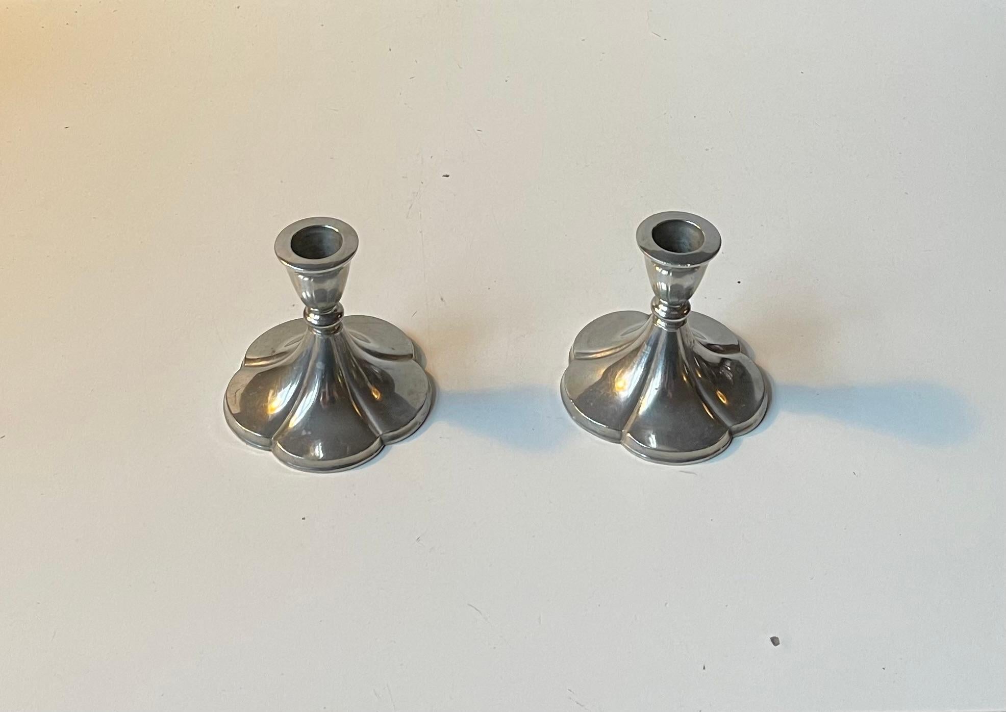 A pair of Candleholders designed and made by Just Andensen in Denmark during the 1930s. They are made from the finest pewter available at the time, probably Selangor. The bases are shaped as five-clovers. Both stamped and signed by Just. Suitable