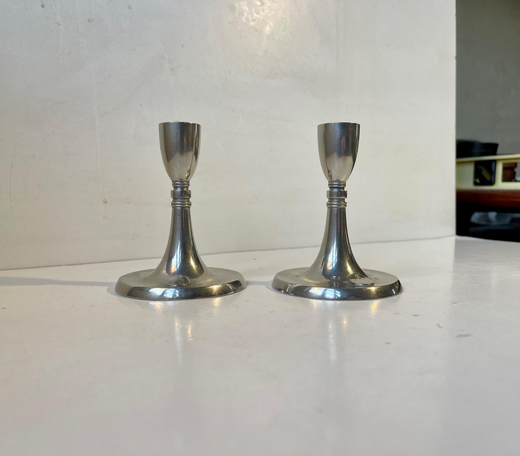A pair of pewter Candlesticks designed by Just Andensen in Denmark during the 1930s or 1940s. Both stamped and signed. Design number: 2732. Suitable for regular sized candles. Measurements: H: 10,5 cm, D: 9 cm.