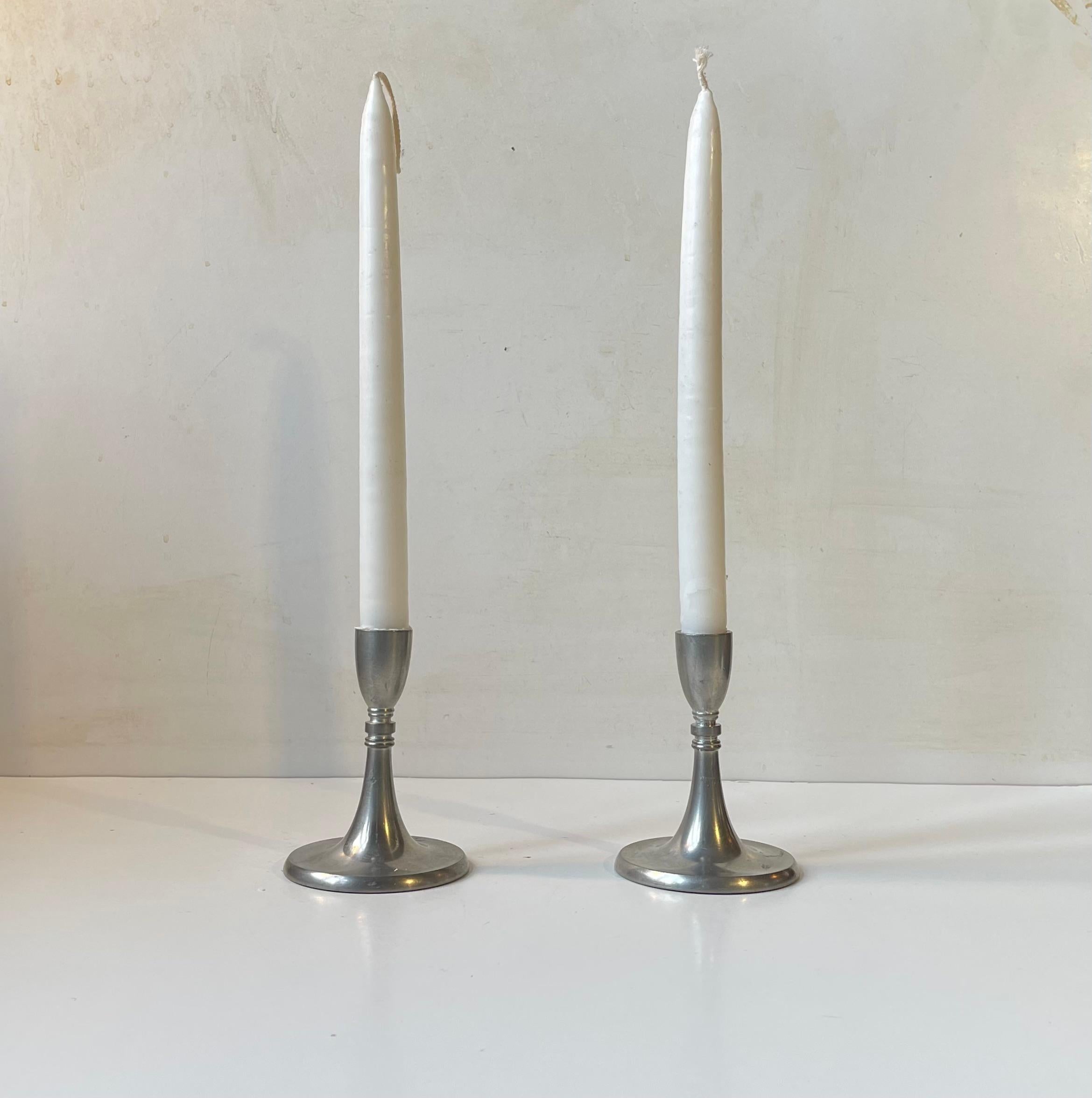 A pair of pewter Candlesticks designed by Just Andensen in Denmark during the 1930s or 1940s. Made from the finest pewter - Selangor pewter (hallmarked). Both stamped and signed by Just.. Suitable for regular sized candles. Measurements: H: 10,5 cm,