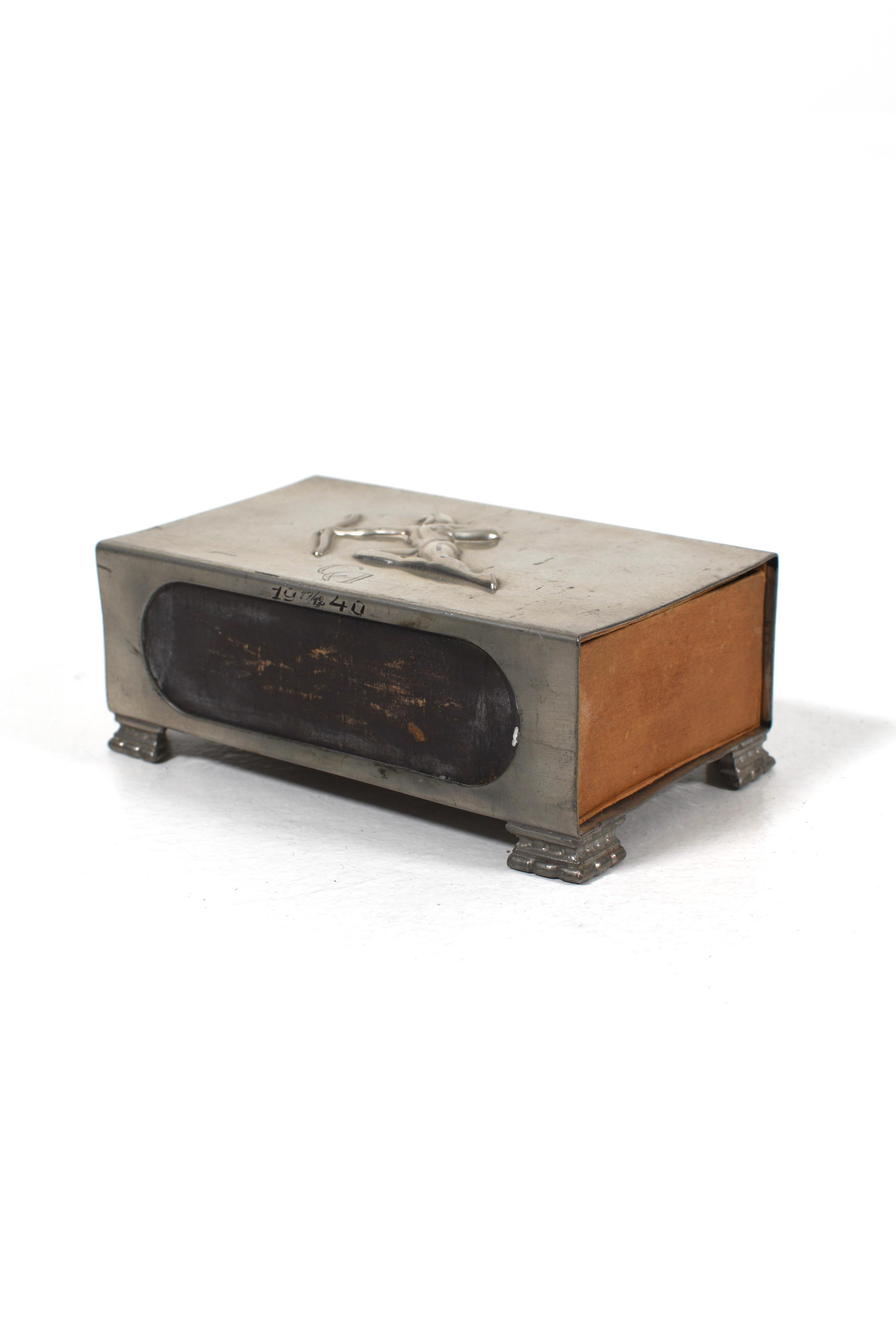 Art Deco matchbox holder in pewter with sculpted archer motif on the lid, dated 1940 and monogrammed 