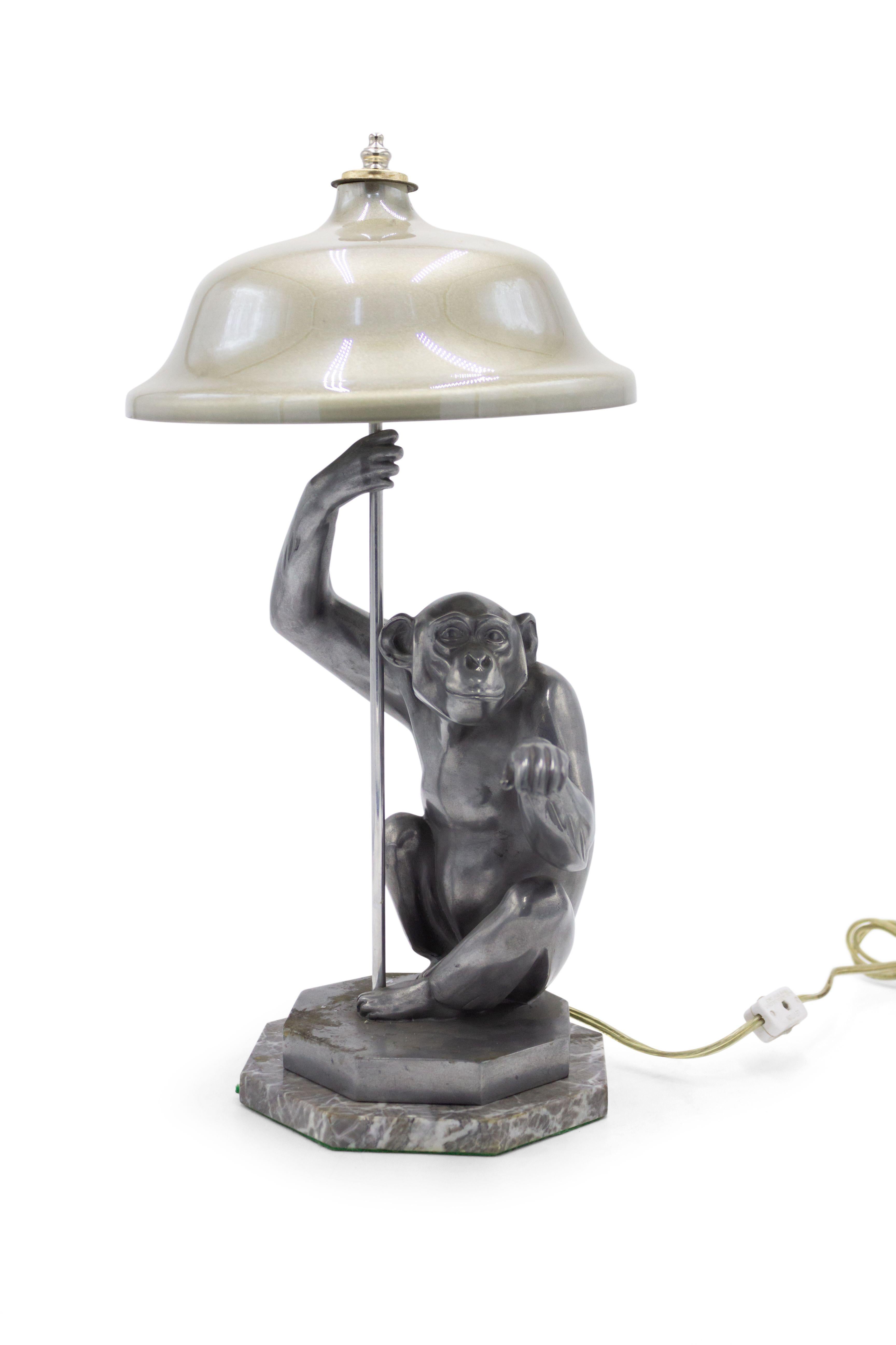 Art Deco style pewter table lamp of seated monkey on octagonal marble base.