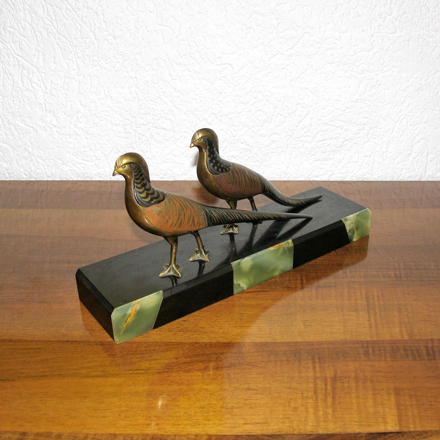 An exquisite original Art Deco sculpture depicting a pair of walking pheasants, by M.Secondo, France, circa 1925.
Multi-color cold painted bronze, with liquid gold accents, mounted on a marble and onyx base. Signed to the base, and each bird on the