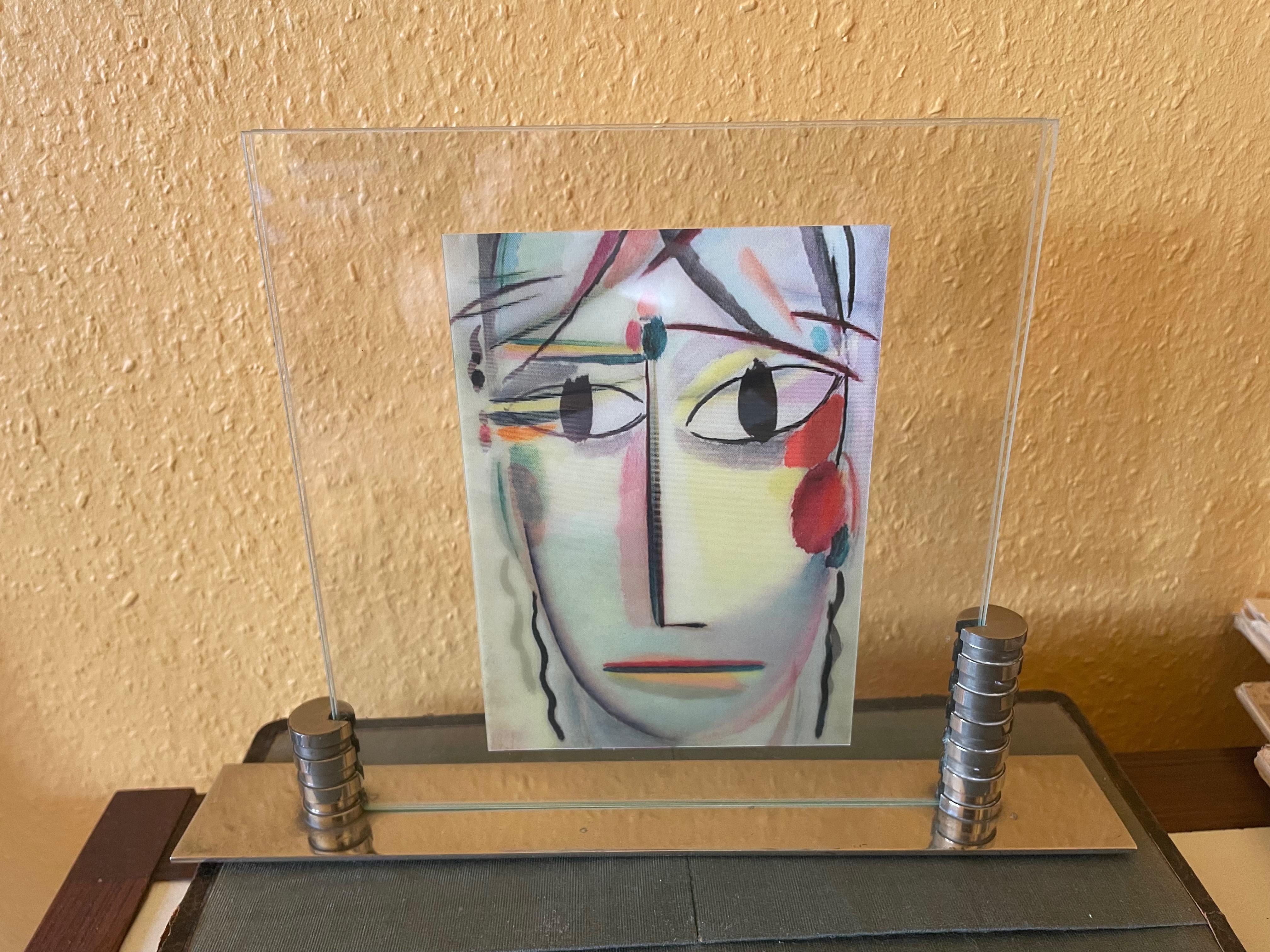 Modernist Art Déco picture frame. France 1920s. 
Nickel plated. Classic modernist Design.
Very good heavy quality. 
Glasses made afterwards.
The dimensions refer to the frame.
The glasses are 18 cm wide and 19 cm high.
The postcard is only a