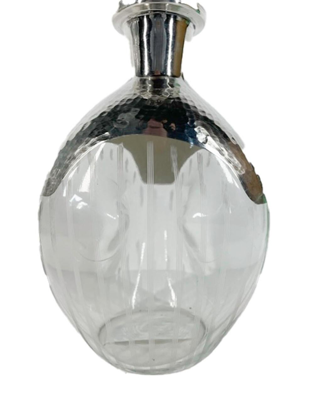 Art Deco three-sided pinch decanter with 2 sides having a large central dimple, the shoulder and top of the mushroom stopper with an overlay of hammered silver and the three sides with vertical etched lines.