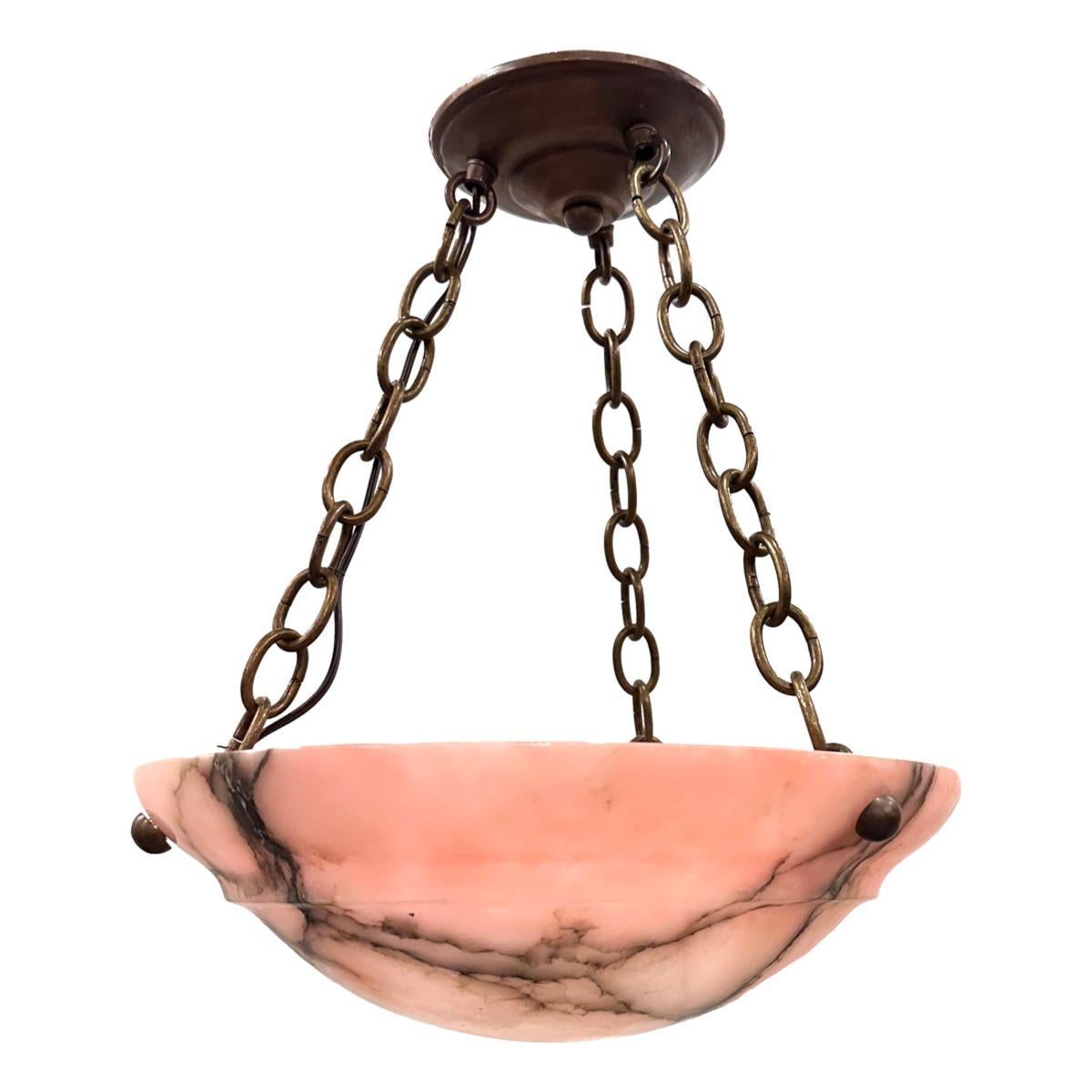 A circa 1920's French pink alabaster pendant light fixture with 3 interior lights.

Measurements:
Drop: 16