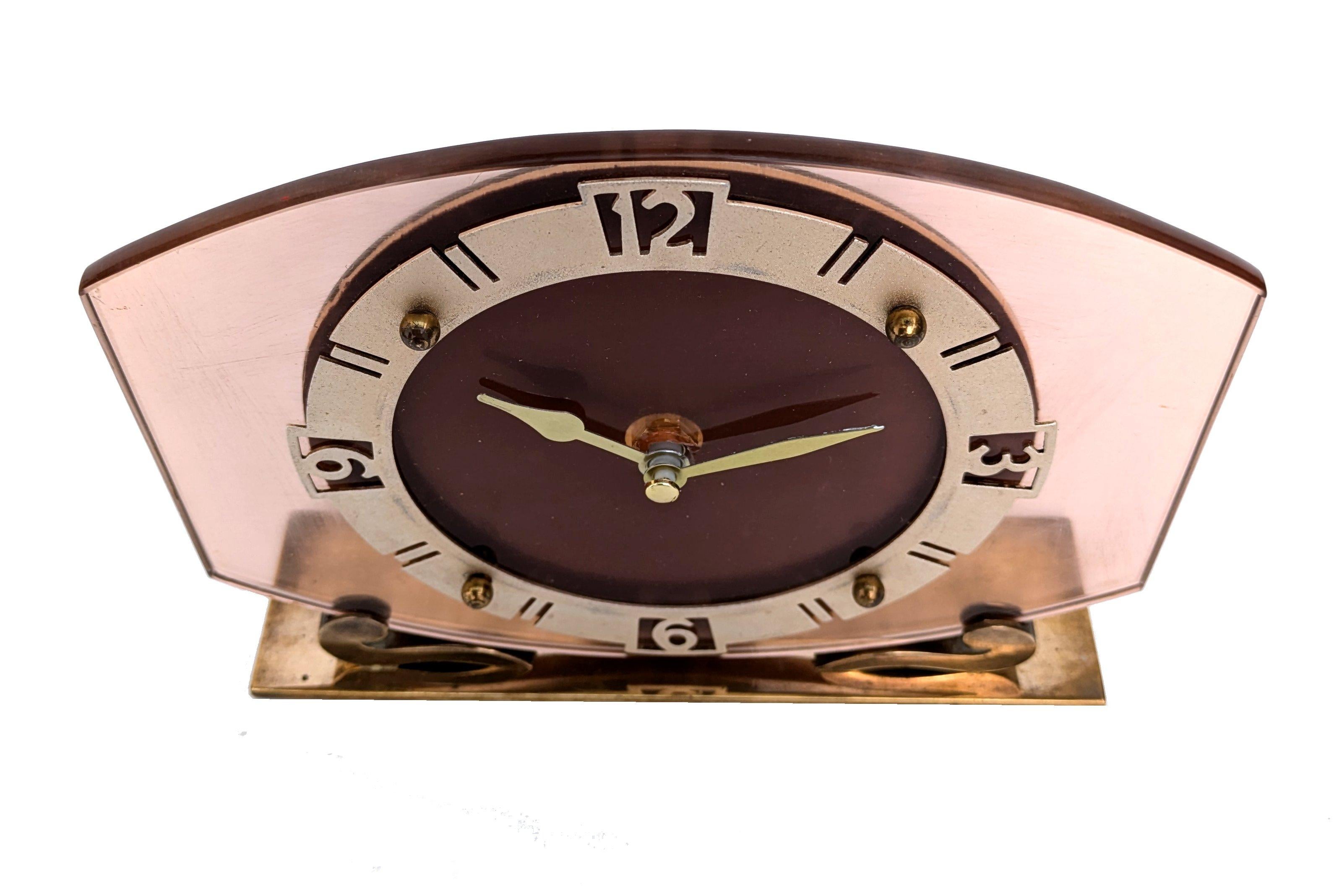 Lovely Art Deco pink glass mantle clock from Smiths clock makers Circa 1930. Fretted out brass bezel. Previously a mechanical wind up clock has been converted to a battery quartz clock now and it is currently working well . Made by Smith's English