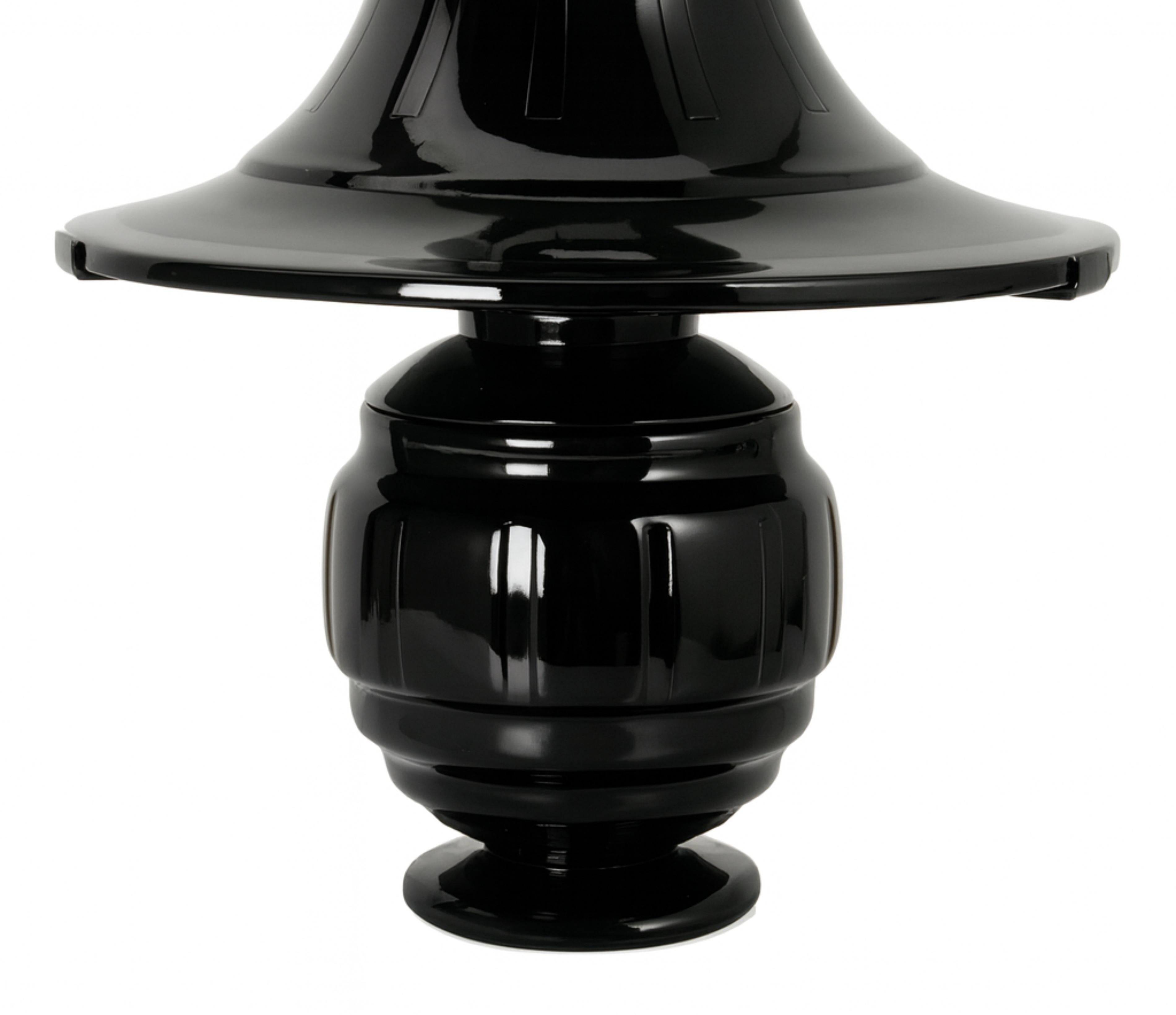 A rare French Art Deco mushroom-shaped black lacquer table lamp from the 1930s, crafted in pink frosted glass with a metal collar.

The soft frosted glass glows warmly when lit, creating a soothing atmosphere, while the bell-shaped shade and bulbous