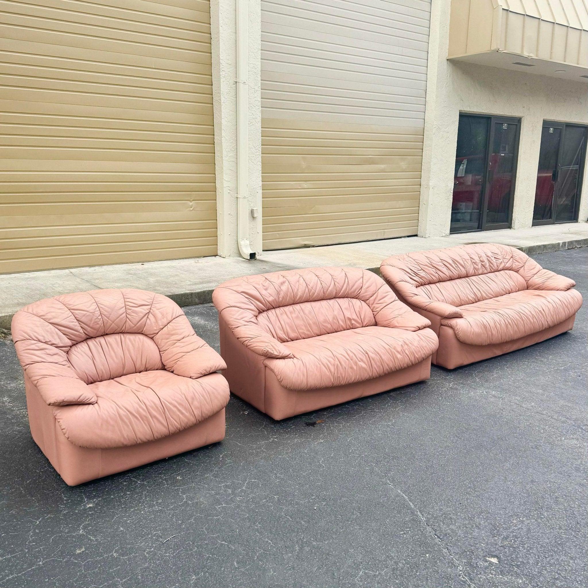 Art Deco Pink Leather Sofa Set with gathered upholstery includes sofa, loveseat, and chair, adding bold vintage elegance and comfort to any space.
 
 Some spotting through out the leather likely from exposure to heat as shown in the photos.
 We sell