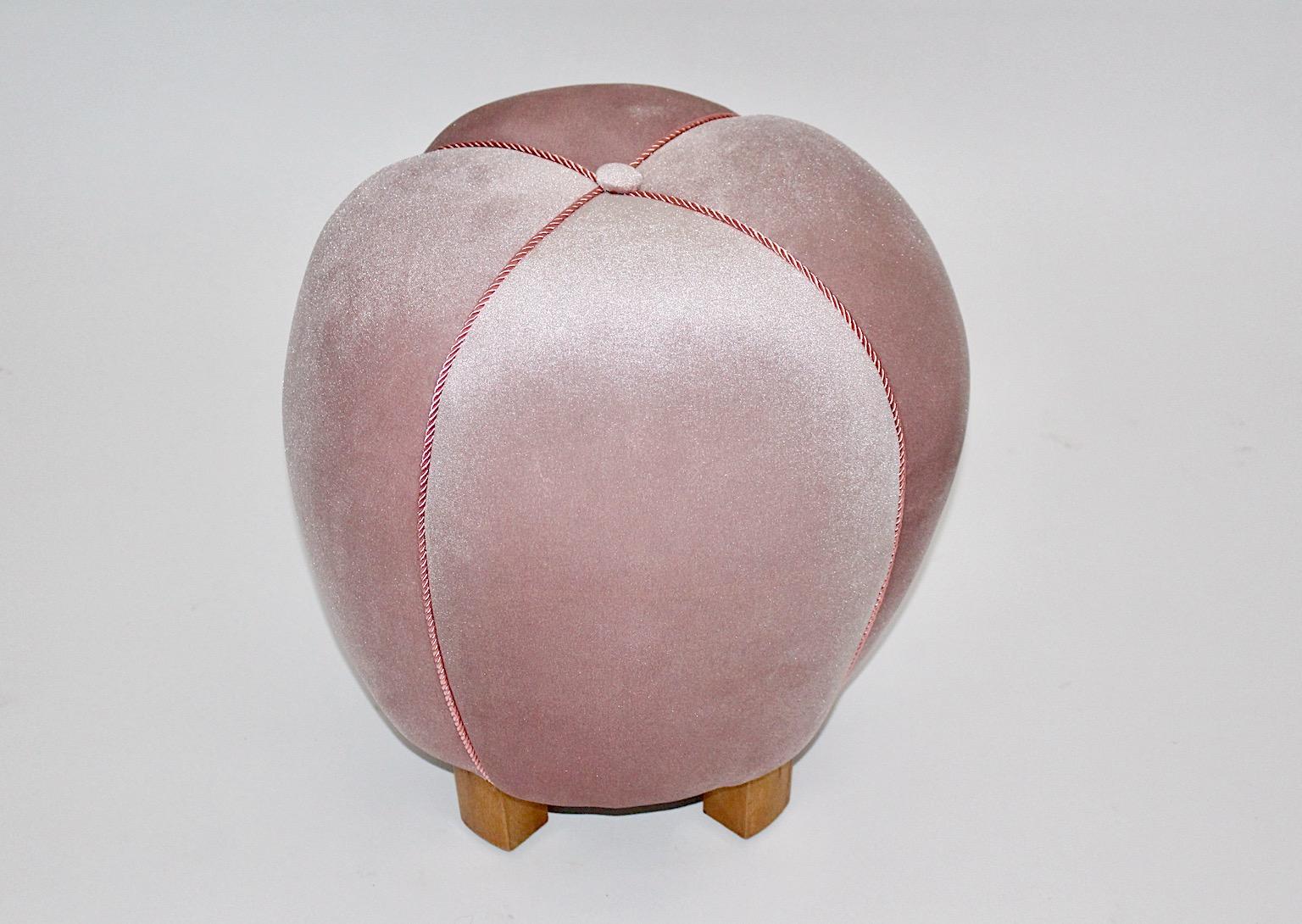 Art Deco vintage pouf or ottoman or stool from beech and pink velvet fabric Austria 1930s.
Very elegant pouf or stool in a beautiful soft pink mauve color, which underlines the certain elegance from the curvy shape.
Decorated with cords in its
