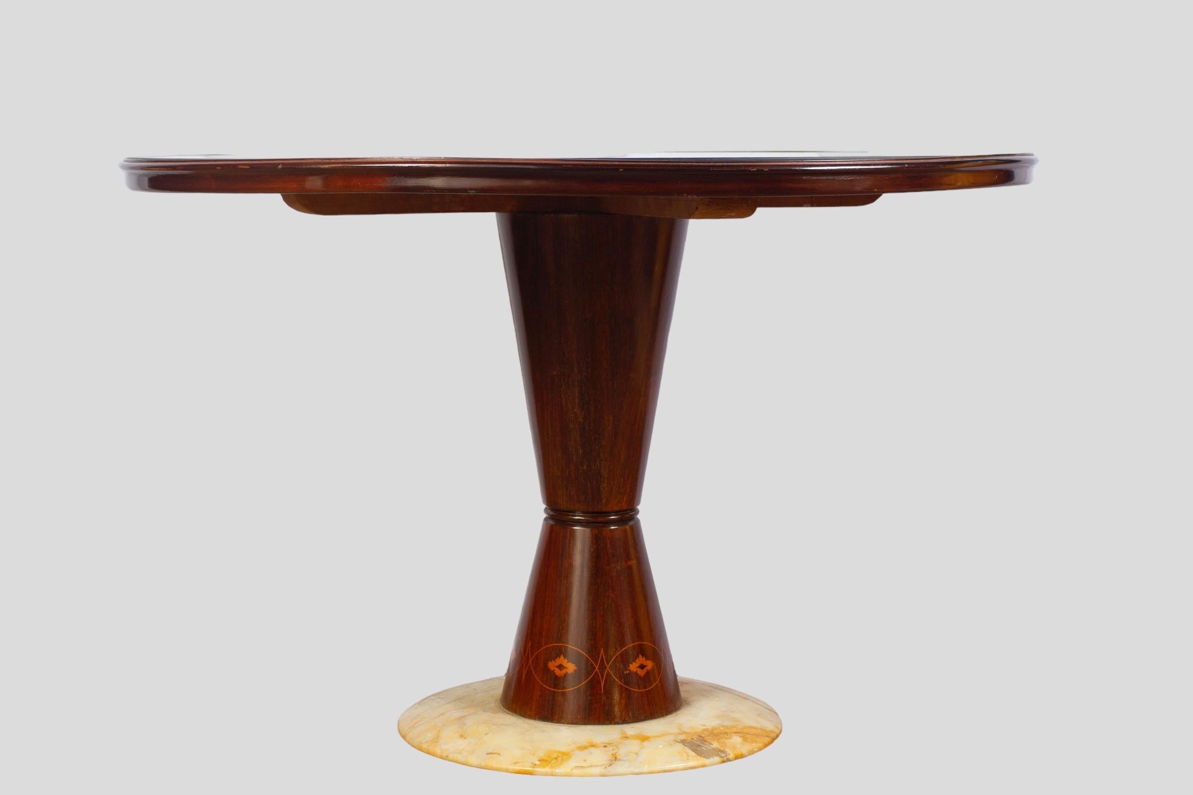 Rare Art Deco round pink mirrored top dining or center table resting on a finely shaped and inlaid leg on a round marble base.
Attribution to Osvado Borsani 
Osvaldo Borsani was a true innovator. Born in 1911, the architect, designer and visionary