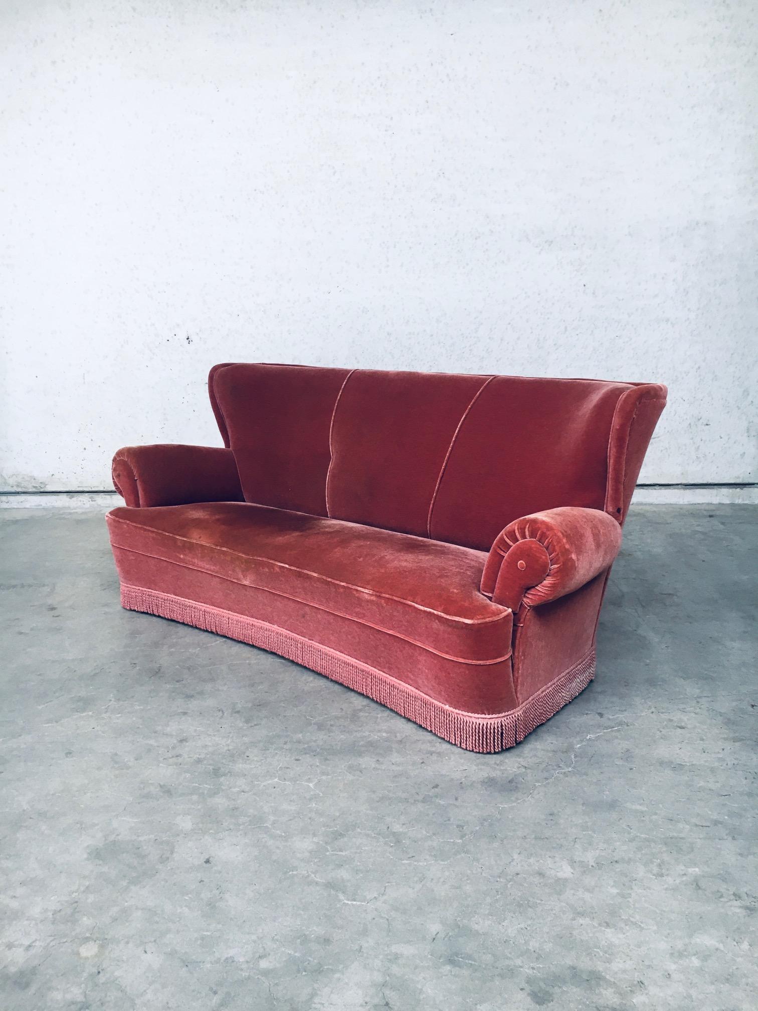 Vintage Art Deco design pink velvet 3 seat sofa with fringe. Made in Italy, 1930's / 40's. Curved large lucious pink velvet three seat sofa with fringed bottom. Spring cushion seating on oak wooden frame. All original very good condition, with minor