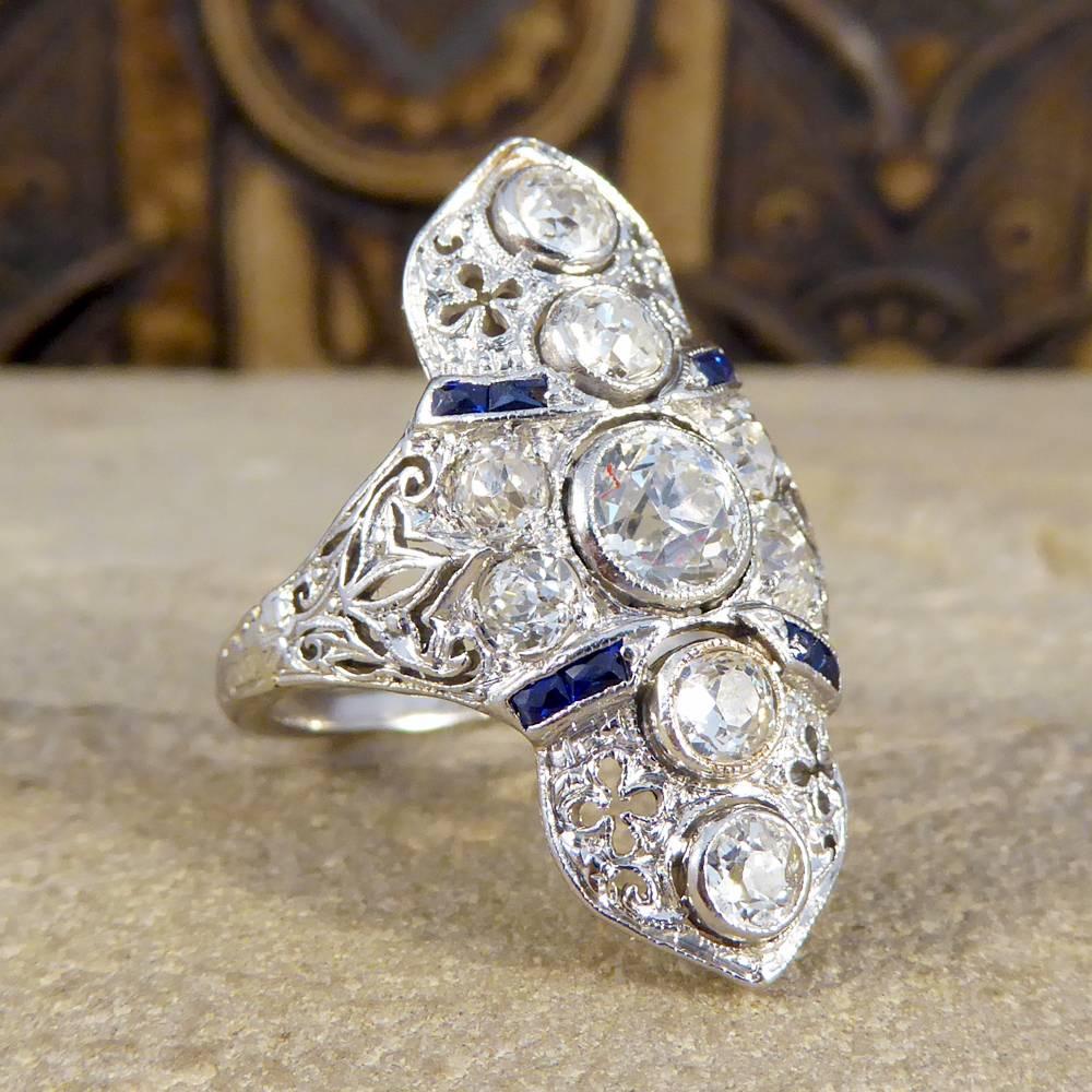 This stunning ring has been crafted in the Art Deco era, an era known for its association with geometric lines and angles and gorgeous detailed pieces like this one. Holding a centre Diamond weighing 0.50ct and with a massive 1.42ct in total this