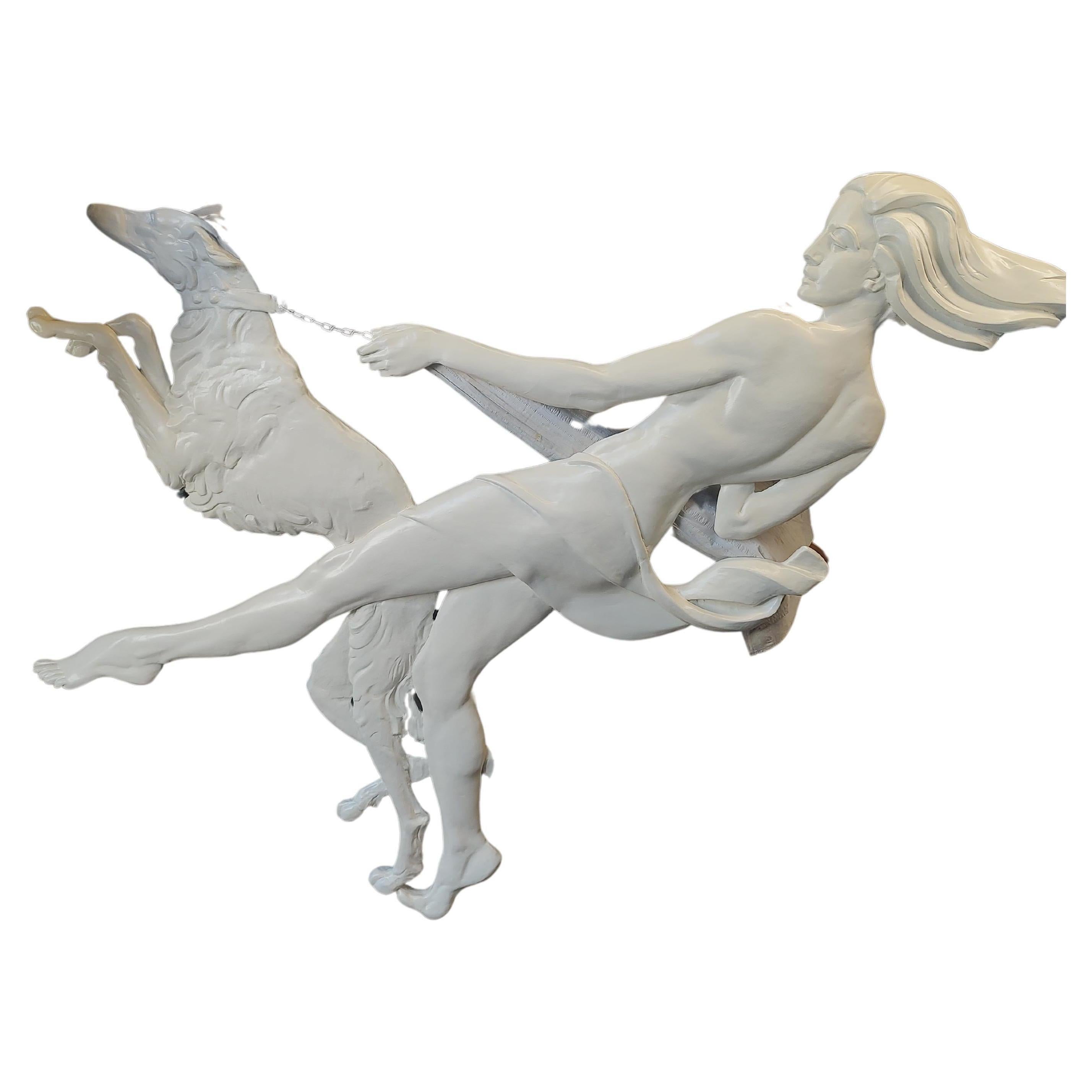 Spectacular and a rare piece from the art Deco period. Fabulous relief of a scantily clad glamorous woman with a Greyhound that looks like it's in motion. The dog is leading the way and the woman is moving at a quick pace. Plaster with steel