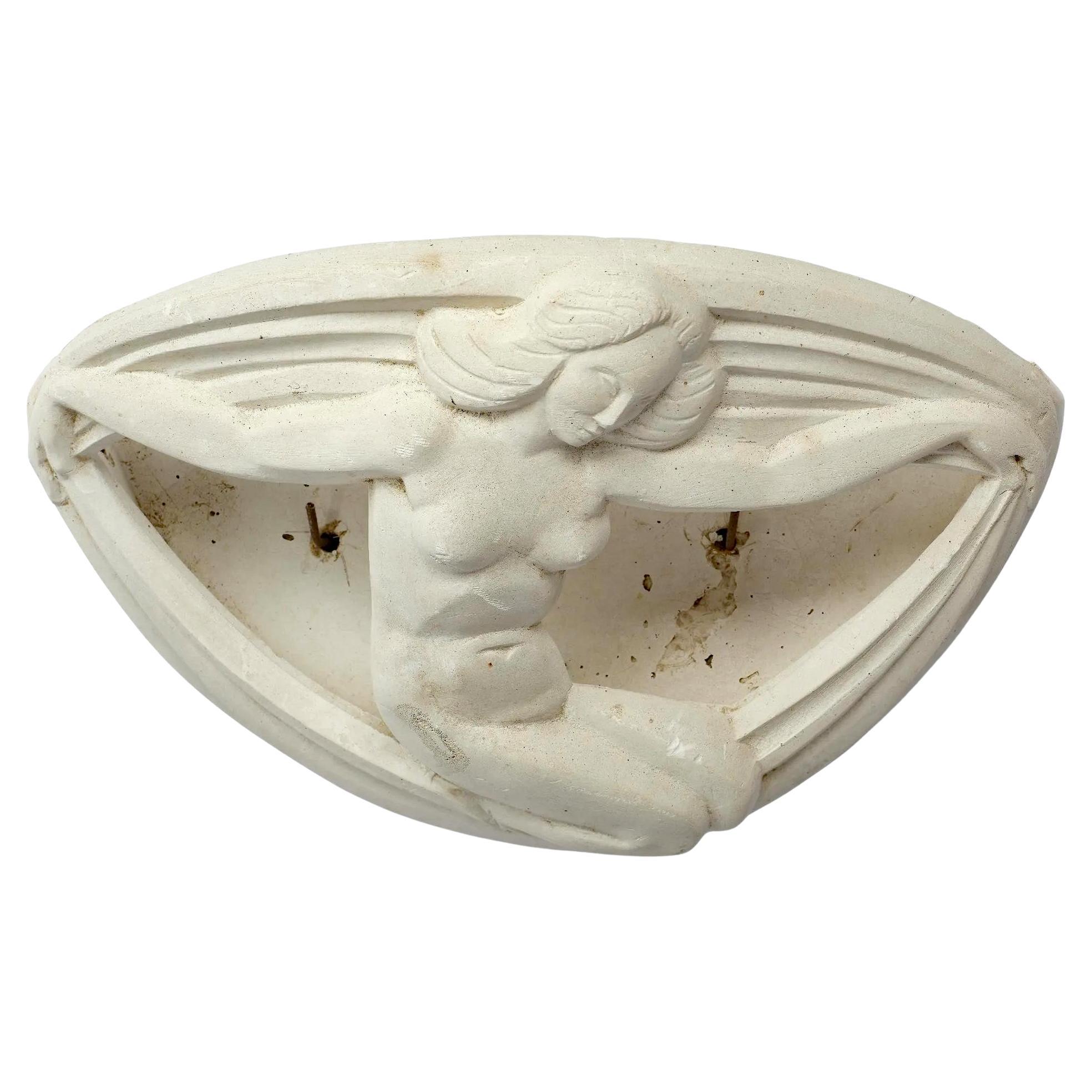 art deco plaster sconce decorated with a dwarf holding drapes circa 1930