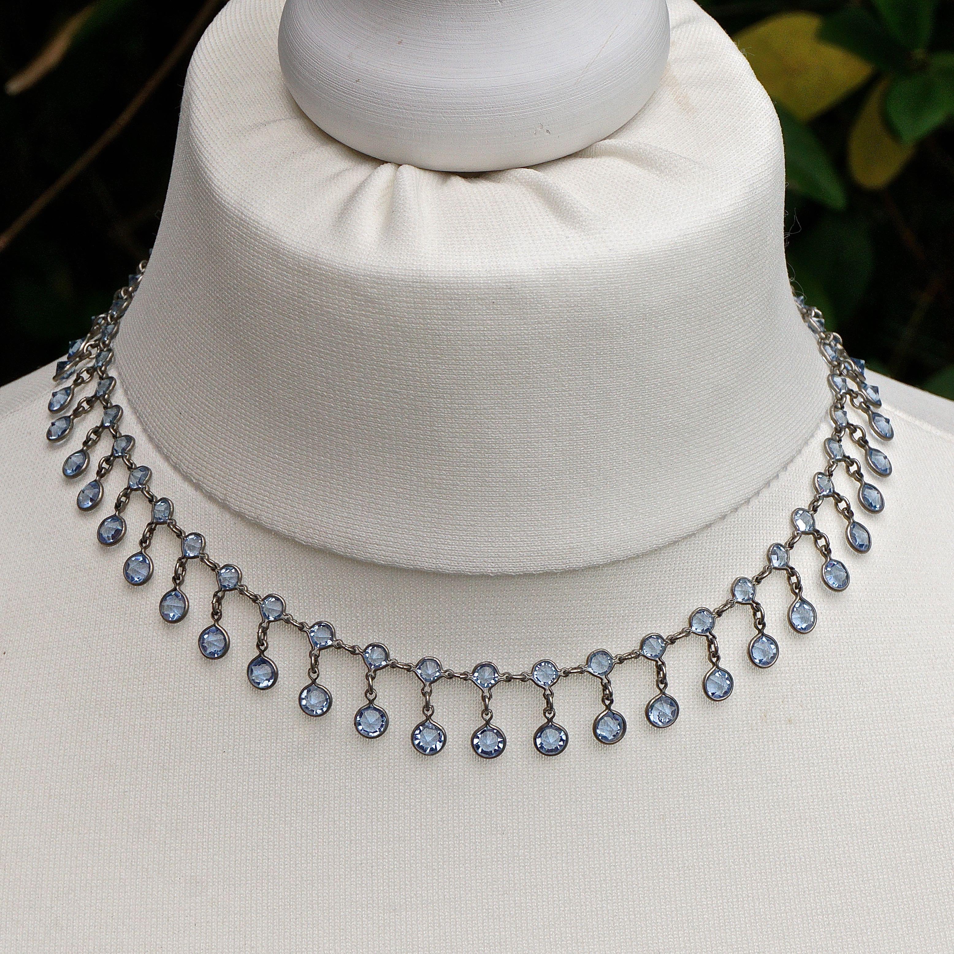 
Beautiful Art Deco Platinon festoon necklace, featuring blue crystal drops. The faceted crystals are raised at the front and pointed at the back, for maximum sparkle. Length 39.5cm / 15.5 inches by width 1.3cm / .5 inch. The necklace is in very