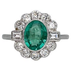 Antique Art Deco Platinum 1.25 Carat Oval Emerald 0.80 Carat Diamond Cluster Ring