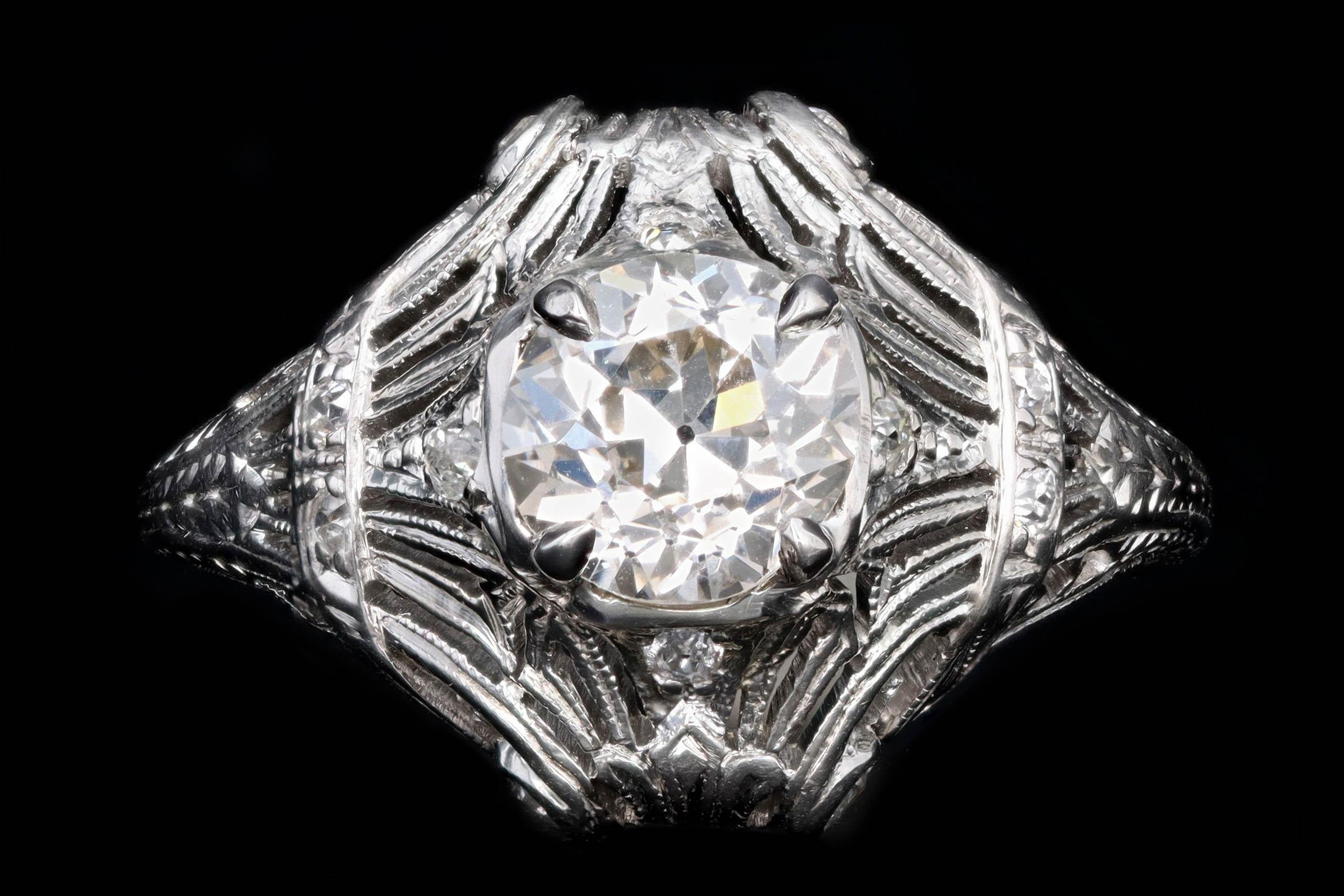 Era: Art Deco

Composition: Platinum 

Primary Stone: Old European Cut Diamond

Carat Weight: 1.31 Carats

Color/Clarity: K / VS2

Accent Stone: Additional Old European Cut Diamonds

Carat Weight: Approximately .15 Carats

Color/Clarity: H / I - VS1