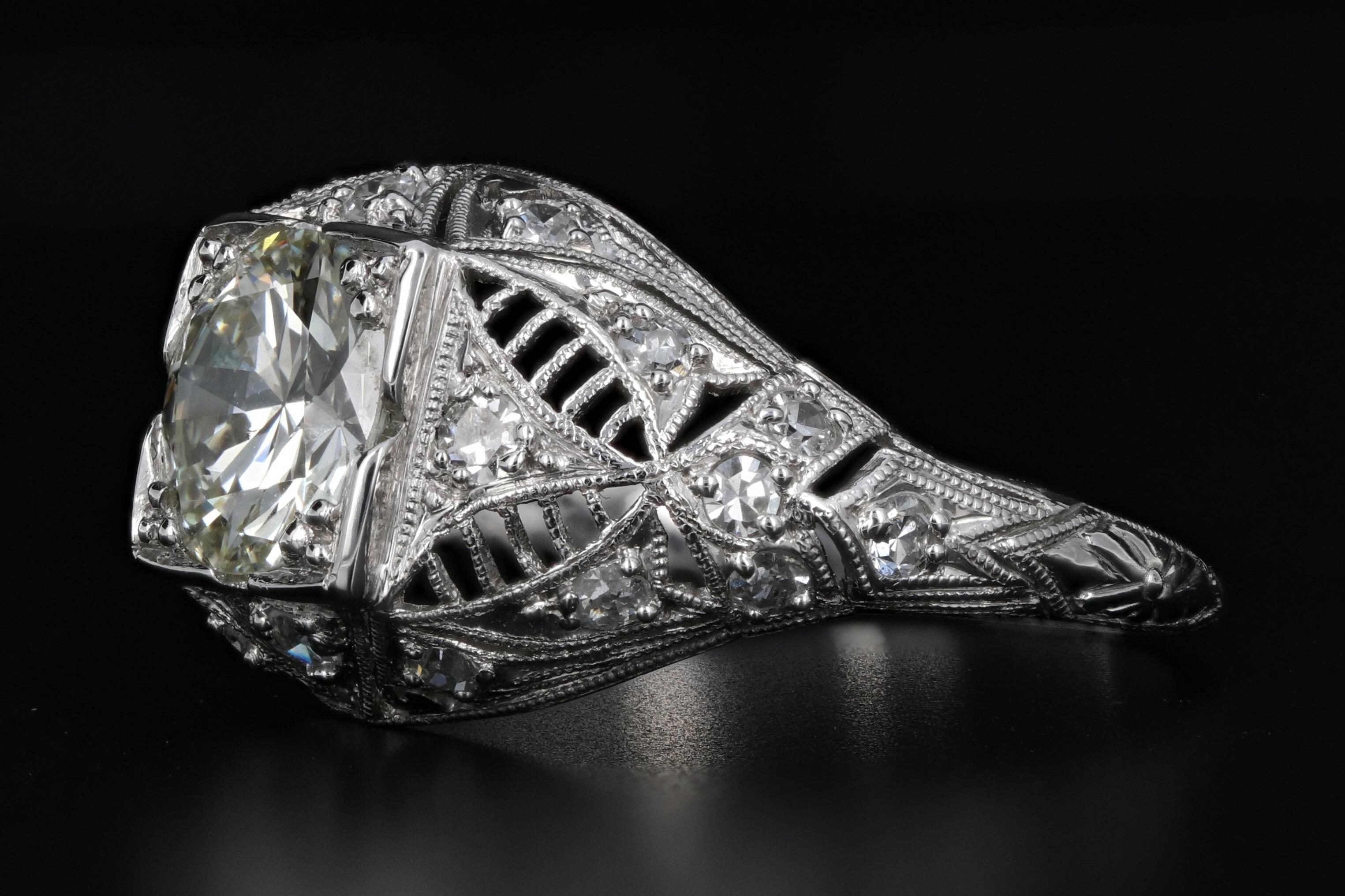 Era: Art Deco

Composition: Platinum

Primary Stone: Diamond

Carat Weight: 1.4 Center Stone

Color: J-K

Clarity: Si1

Secondary Stone: Diamond (24 Single Cuts)

Carat Weight: .36 CTW

Color: G-H

Clarity: Vs2-Si2

Size: 7.25

Total Carat Weight: