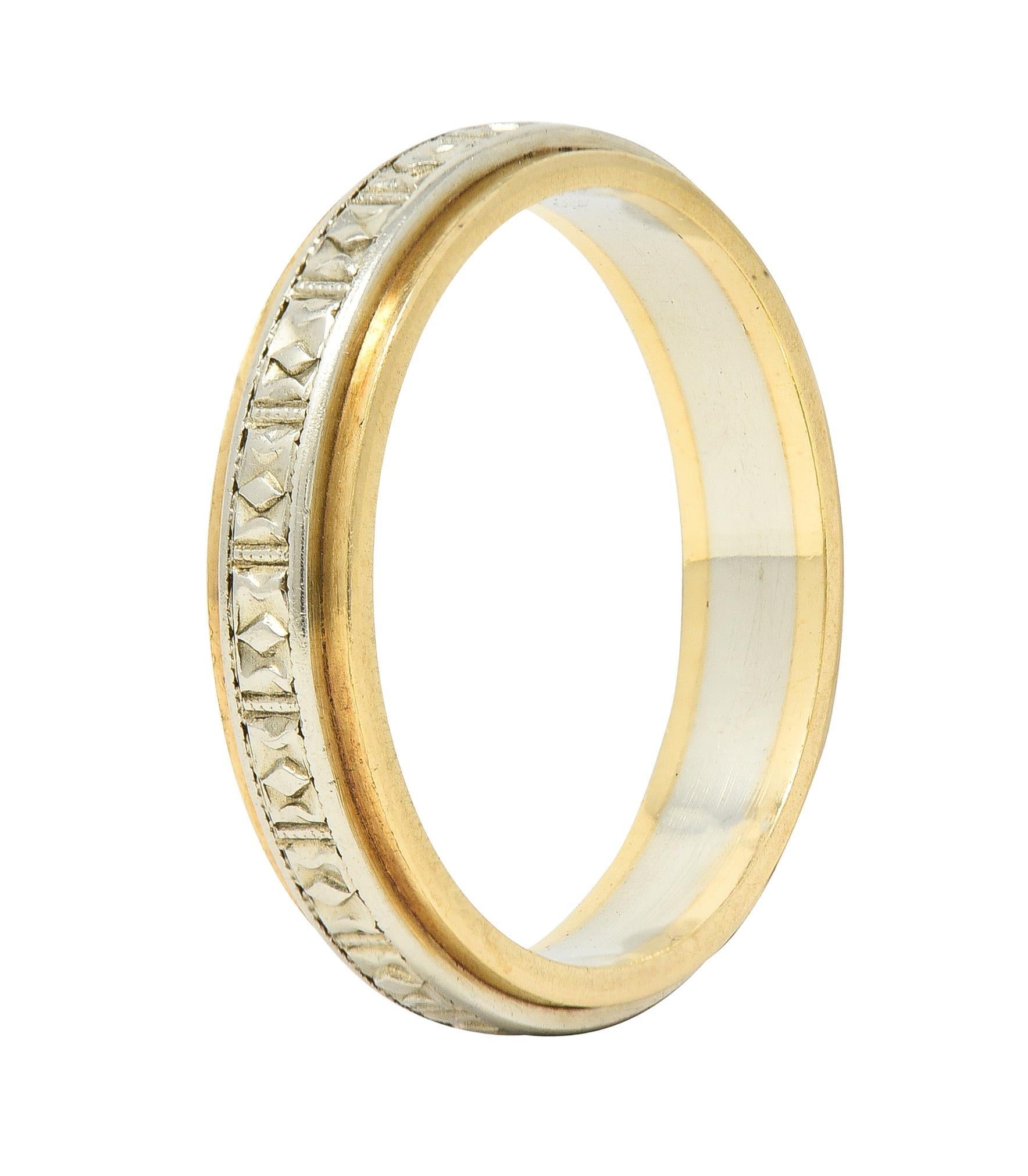 Designed ad a yellow gold band centeirng a raised white gold band
With engraved geometric diamond pattern fully around
Tested as 14 karat gold 
Circa: 1930s
Ring size: 6 and not sizable
Measures north to south 4.0 mm and sits 1.5 mm high
Total