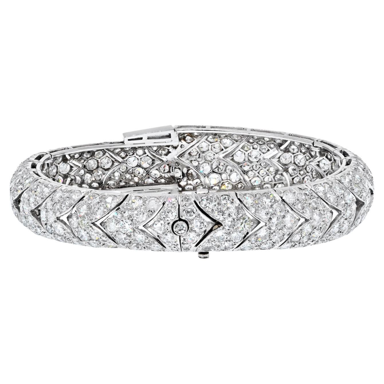 This is a very special bracelet from the Art Deco era, crafted circa 1930's in platinum with diamonds. 
Mounted with over 400 diamonds of old cut round shapes and a few baguettes. Lovely sparkle, clean overall. 
Perfect for a wrist size 6.25in to