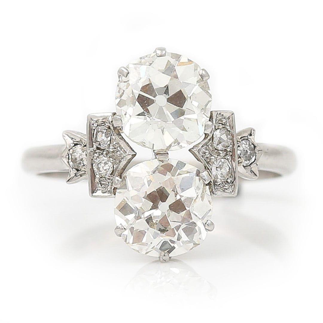 A stunning original Art Deco 2.48ct old European cut two stone diamond ring crafted in platinum and dating from circa 1920. The two perfectly matched round cut diamonds are certified as K-L colour and SI clarity with lots of scintillation and