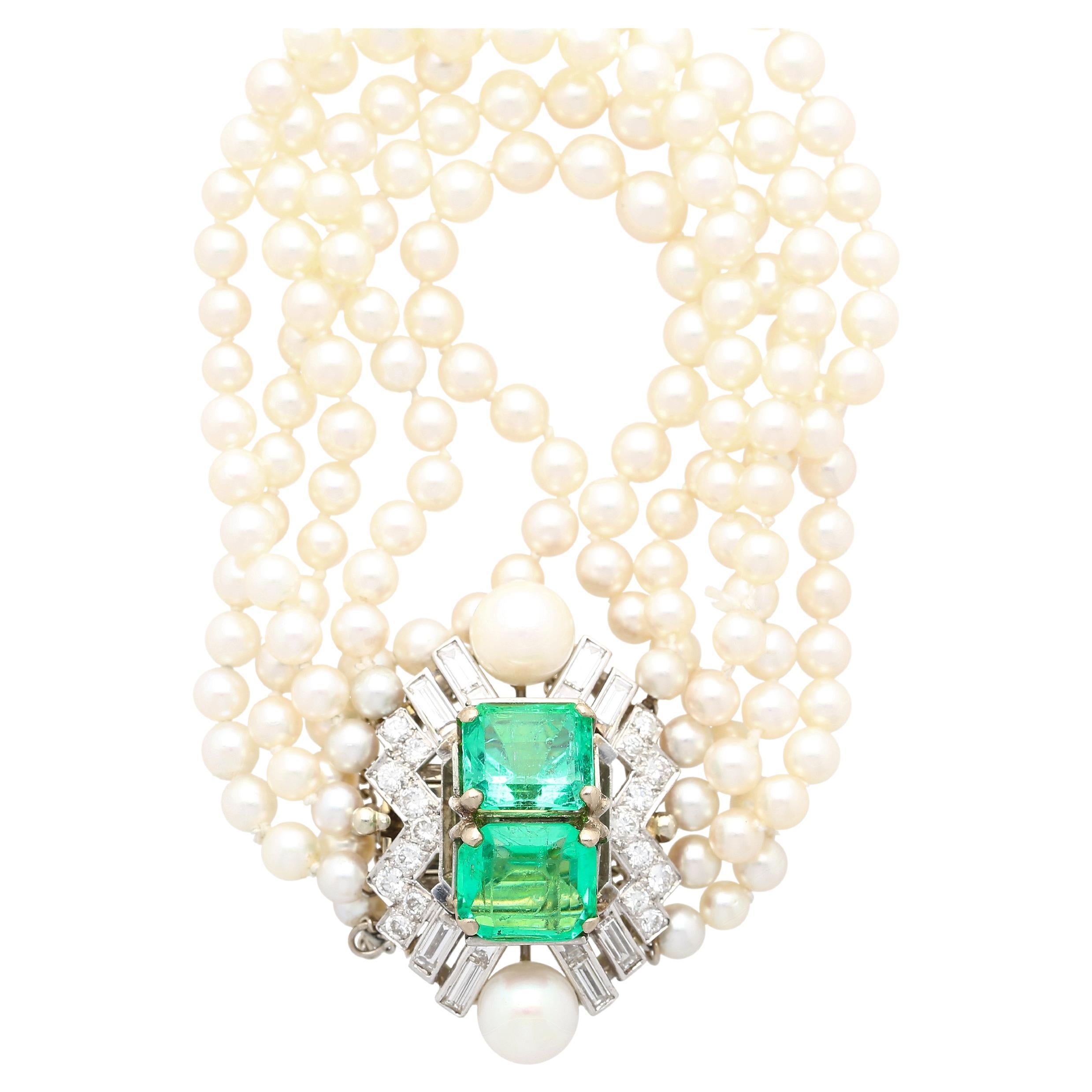 Indulge in the allure of our captivating Art Deco bracelet, featuring a fusion of elegance and vintage charm. Adorned with five rows of 8.25 and 4.6 MM of natural pearls. Enhancing its allure is 8 carats of vibrant light green emeralds taking center