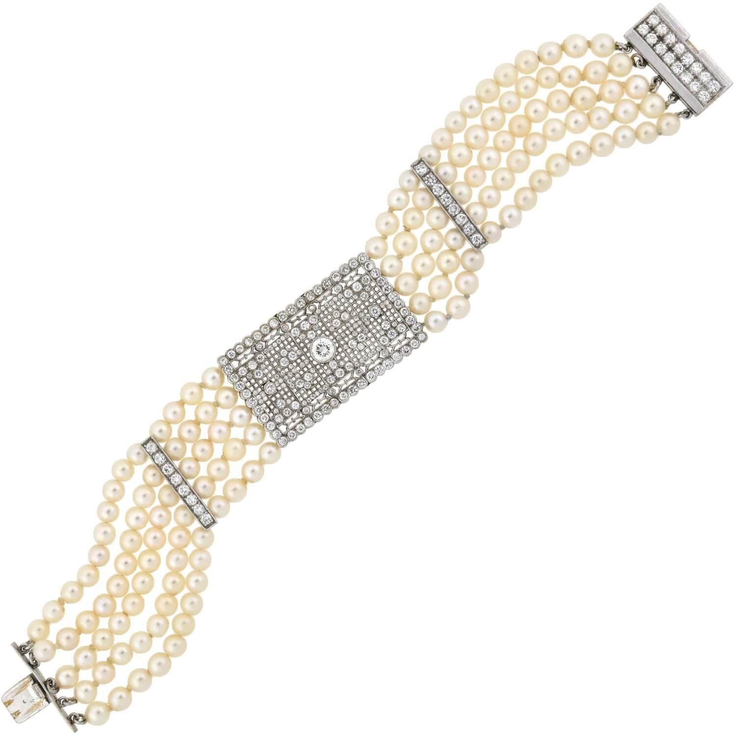 An absolutely lovely pearl bracelet from the late Art Deco (1930s) era! This stunning piece is comprised of five strands of delicate cultured pearls, which have a rich creamy color and beautiful luster. An open wirework centerpiece, comprised of