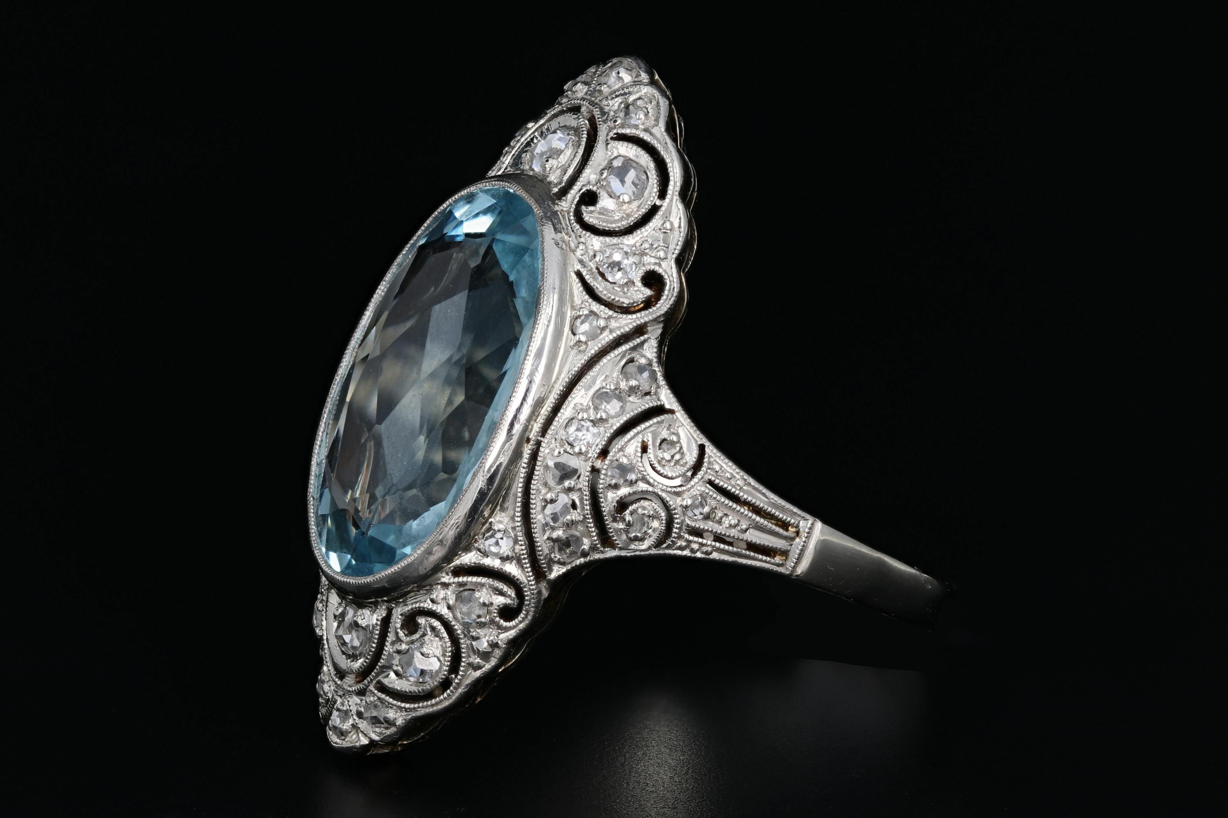 Era: Art Deco

Hallmarks: 585

Composition: Platinum and 14K Ring Shank

Primary Stone: Aquamarine

Stone Carat: Approximately 5.6 carats

Shape: Oval Cut

Accent Stone: Rose Cut Stones

Ring Width: 3cm

Rise Above Finger: 6.75mm

Ring Size: