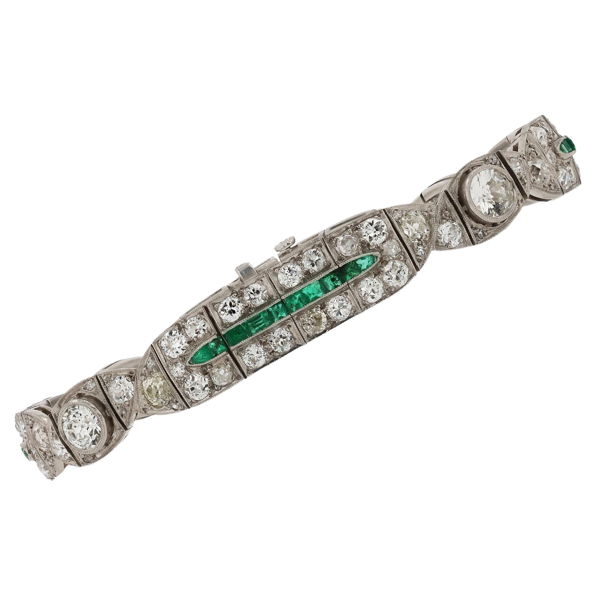This antique 1920s bracelet is in a league of its own regarding exquisite beauty and the distinct craftsmanship of the era. Displaying Art Deco's signature styles flanked with rows of enchanting old cut diamonds and calibre cut emeralds. Each
