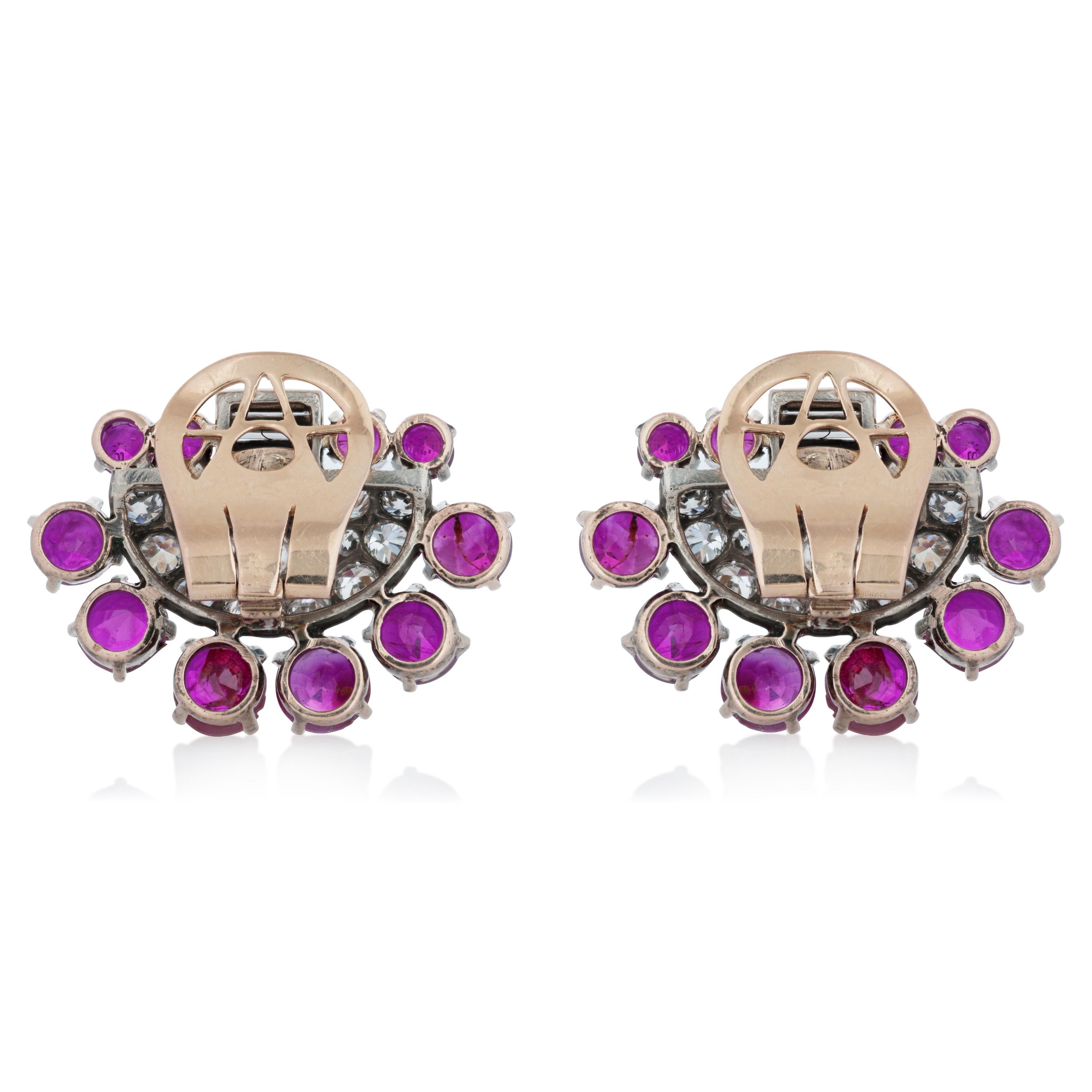 Art Deco platinum and 14k yellow gold Burma ruby and diamond clip on earrings accompanied by an AGL report.  These ear clips feature 20 mixed shape unheated Burmese rubies weighing an approximate total of 12.00 carats set around a mixture of round