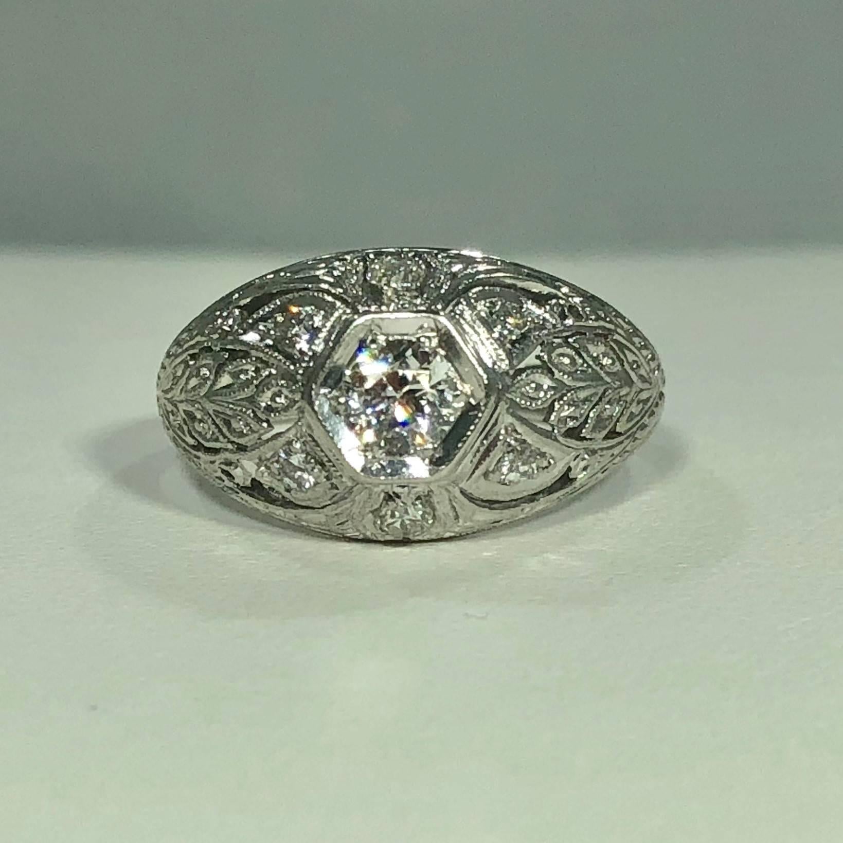 Art Deco Platinum and 18 karat European cut diamond dome engagement ring. This true Art Deco piece is stunning. Created in Platinum and 18 karat white gold with exquisite filigree detail. The center stone is a European cut diamond .25 carat approx.,