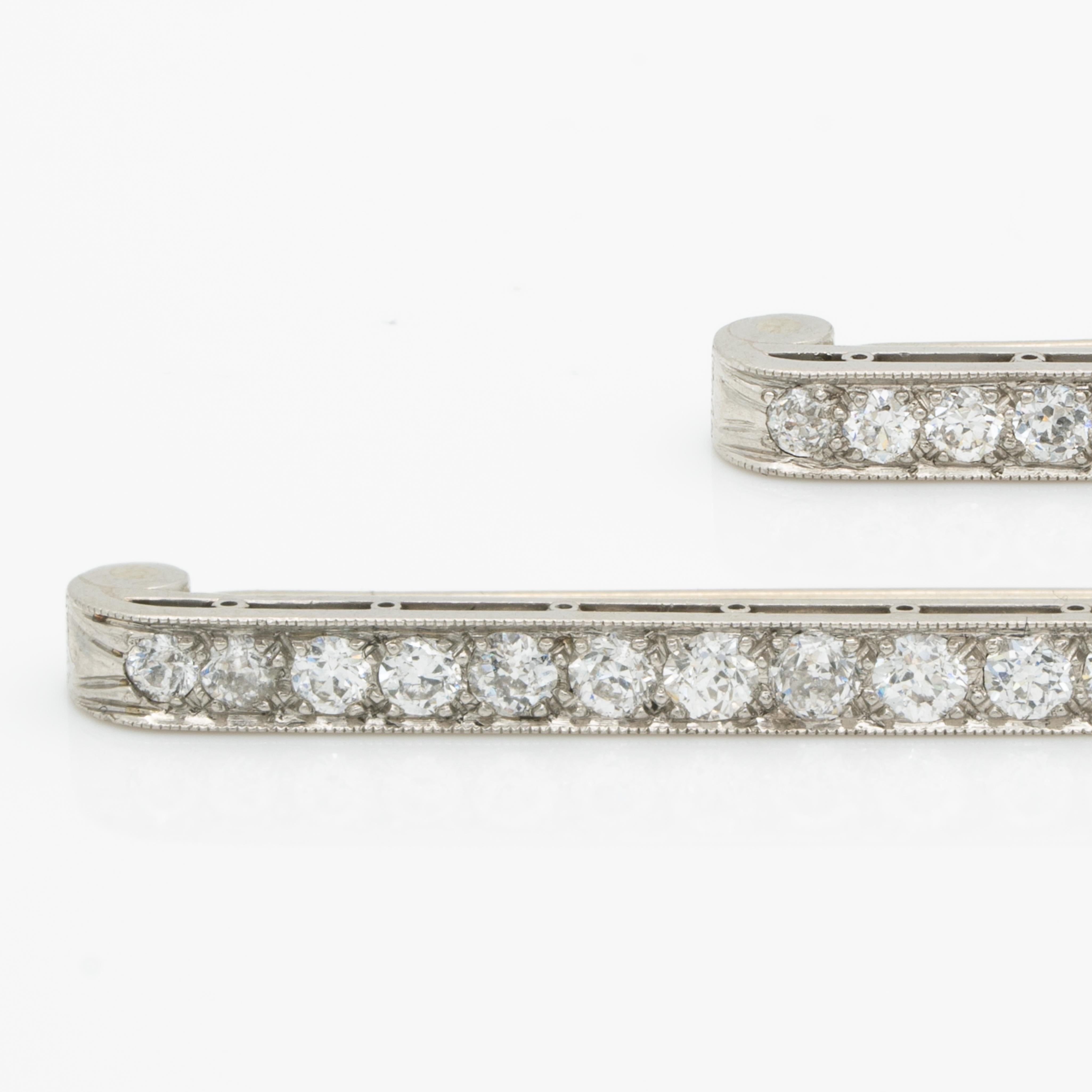 Art Deco Platinum and 2.0 cts Diamond Matching Pair Bar Brooches c.1925

Period: Edwardian
Year: c.1925
Material: Platinum and 2.0cts. Old European Cut Diamonds
Weight: 6.42g (Weight of Pair)
Height:38.7 mm/1.52 inches 
Width: 3.24mm/0.18